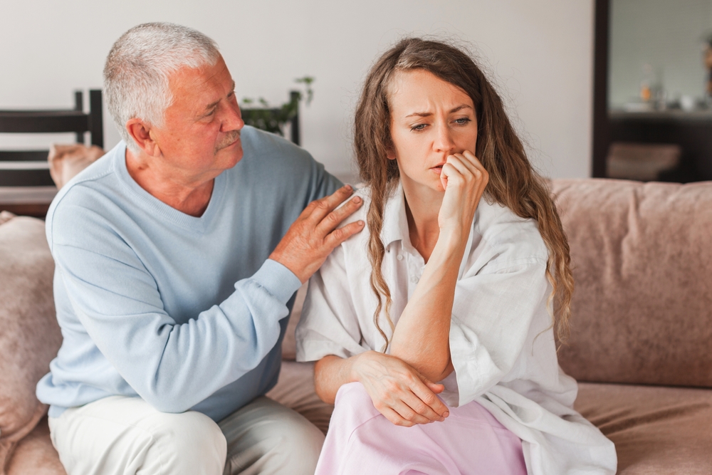 An older man comforting a young woman | Source: Shutterstock