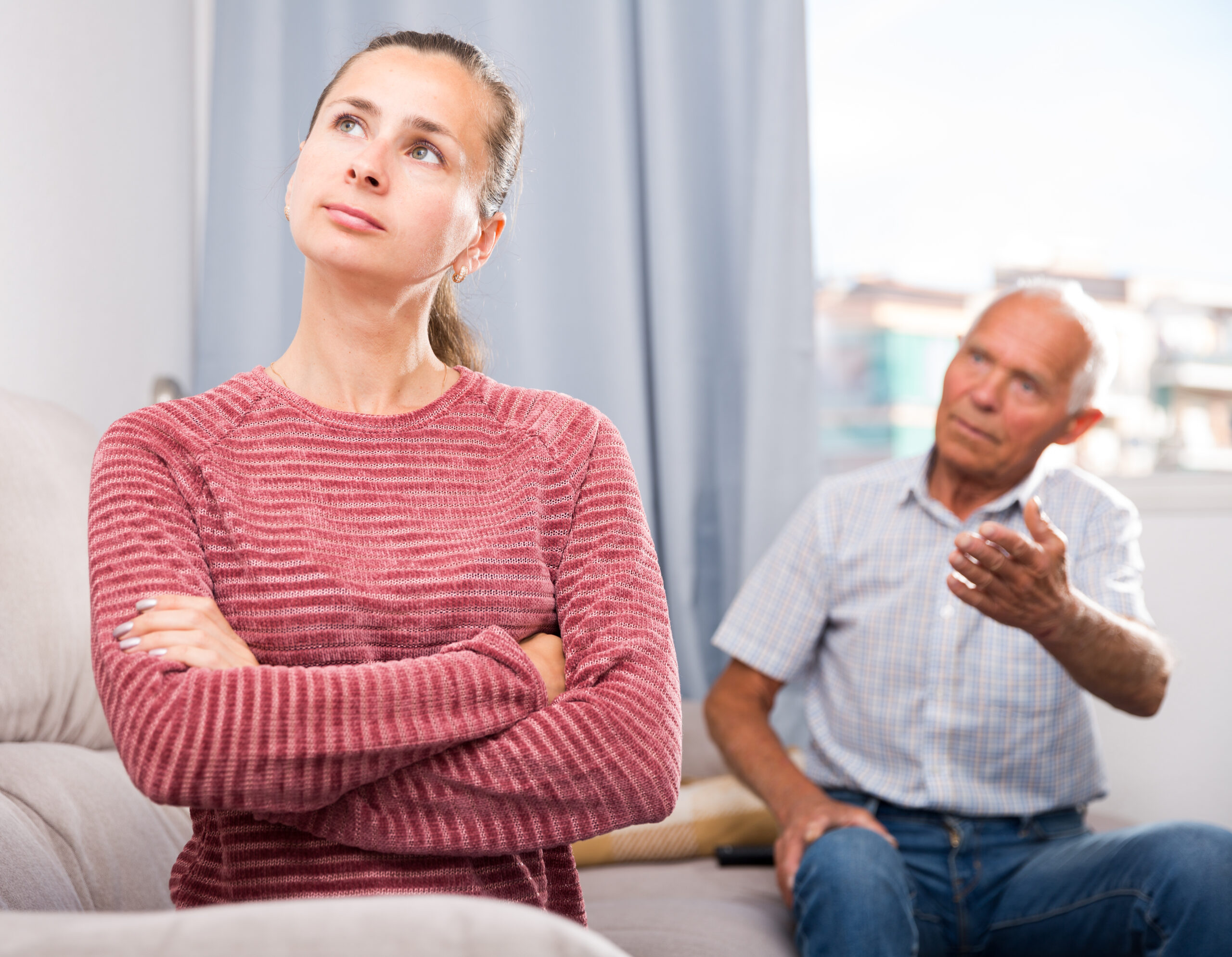 An older man having a heated discussion with a younger woman | Source: Shutterstock