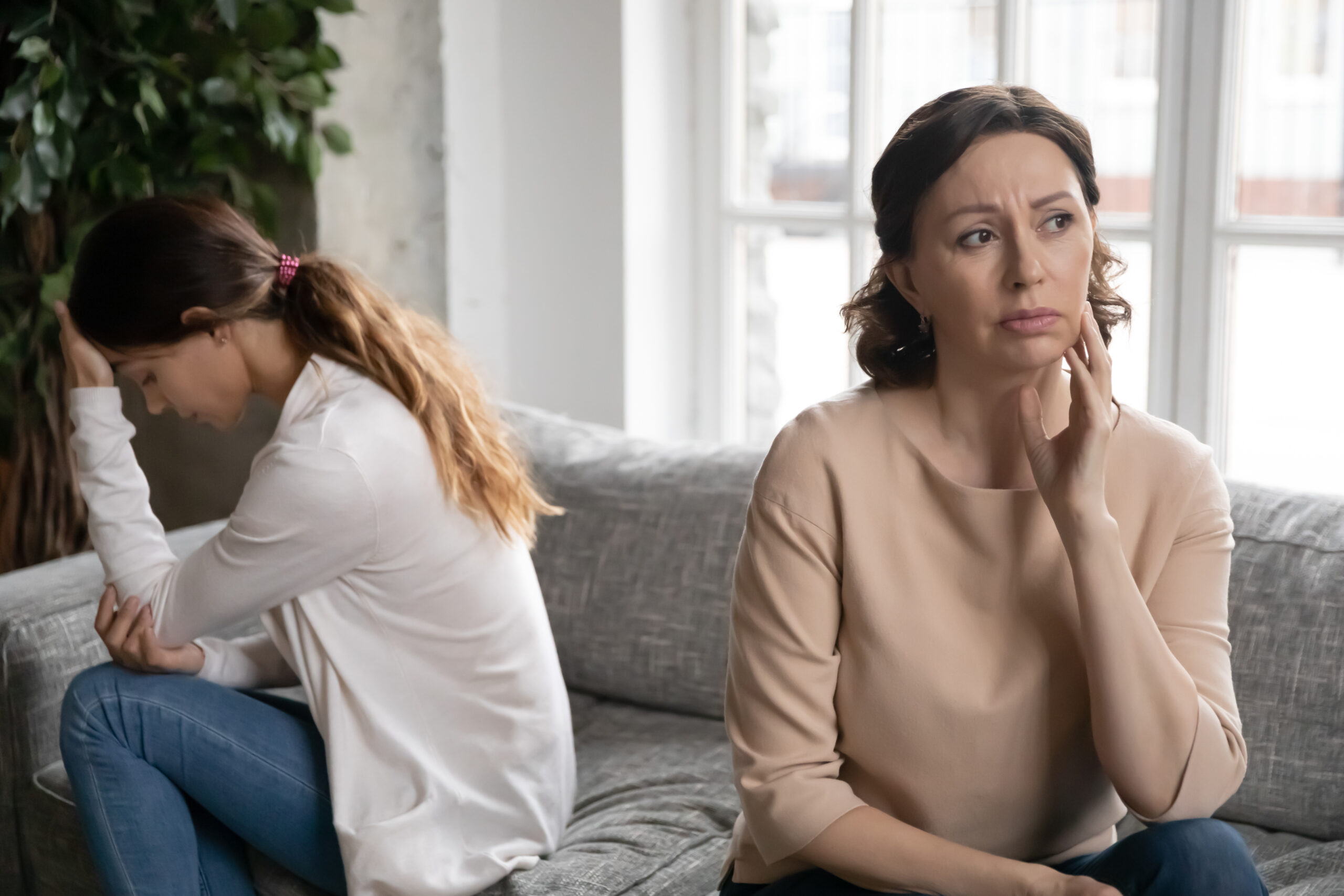 A mother and daughter on a sofa after a fight | Source: Shutterstock