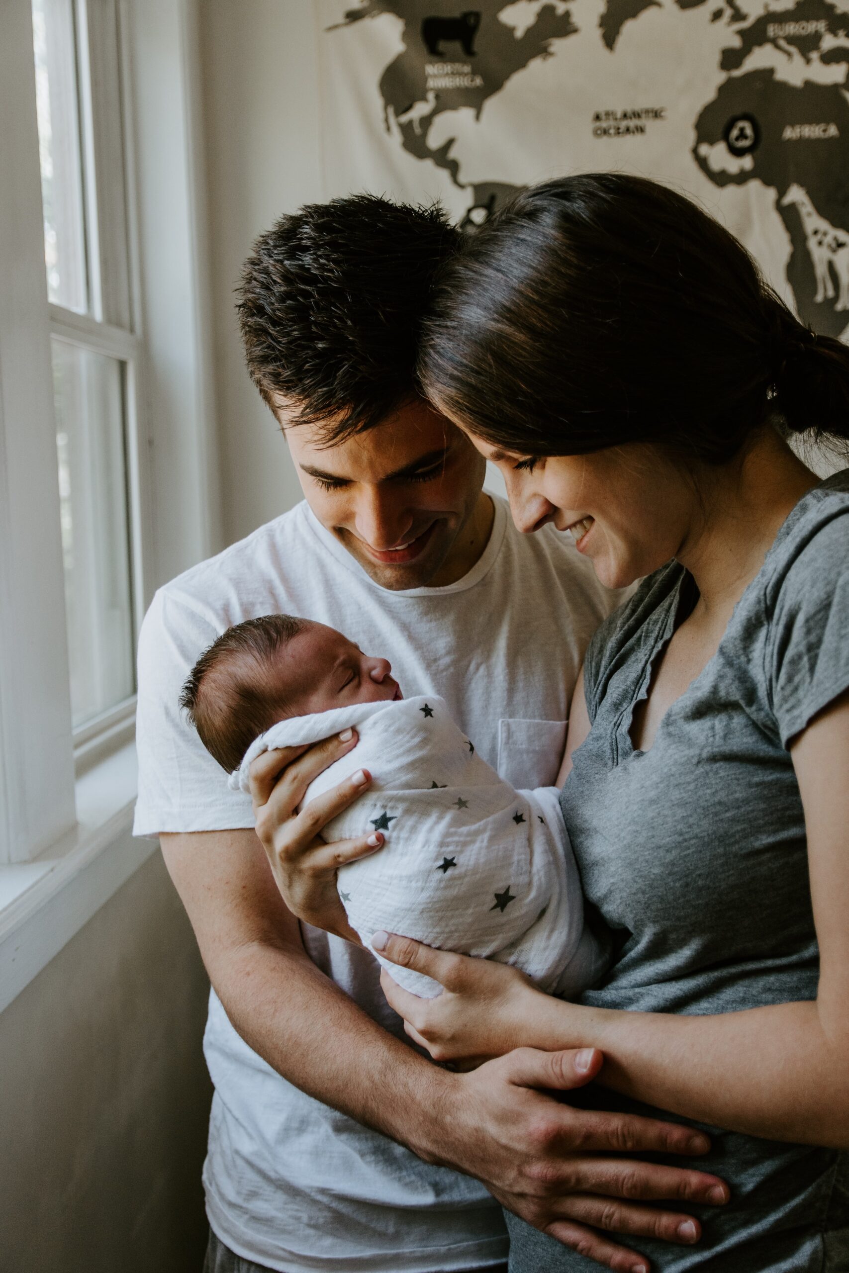 A couple holding their newborn baby | Source: Unsplash