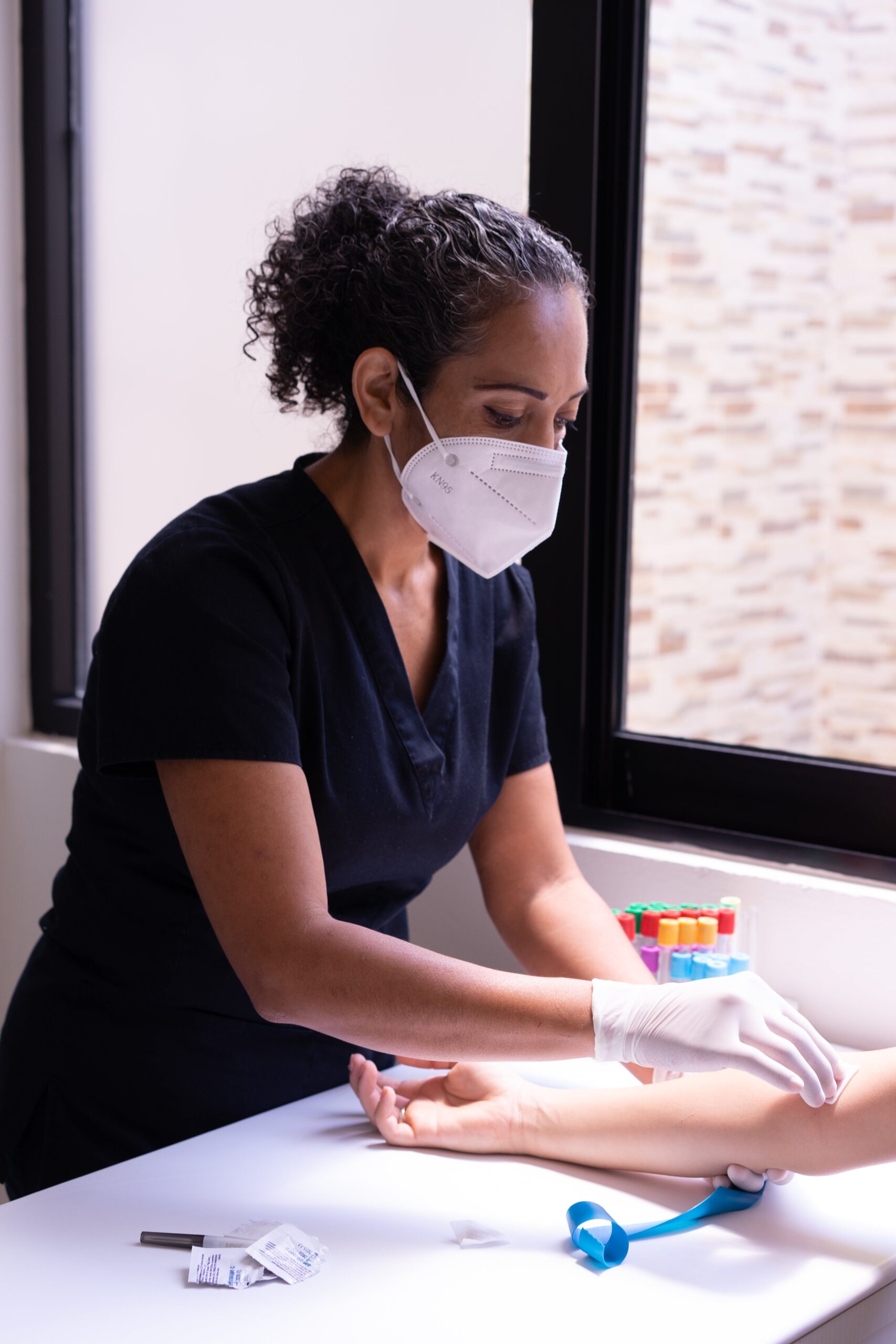 A medical professional taking blood from a patient | Source: Pexels