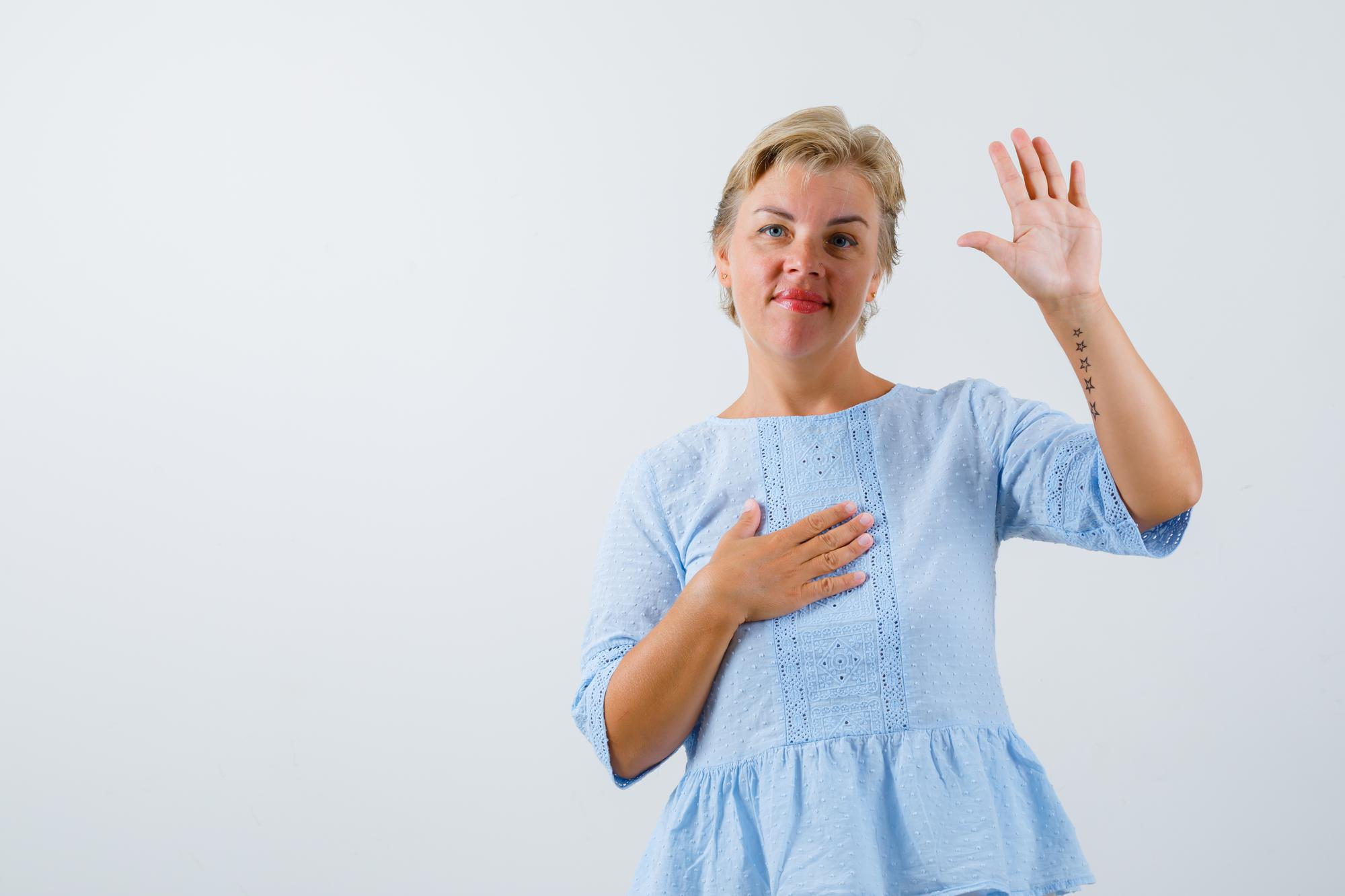 A woman holding her hand up to object to something | Source: Freepik