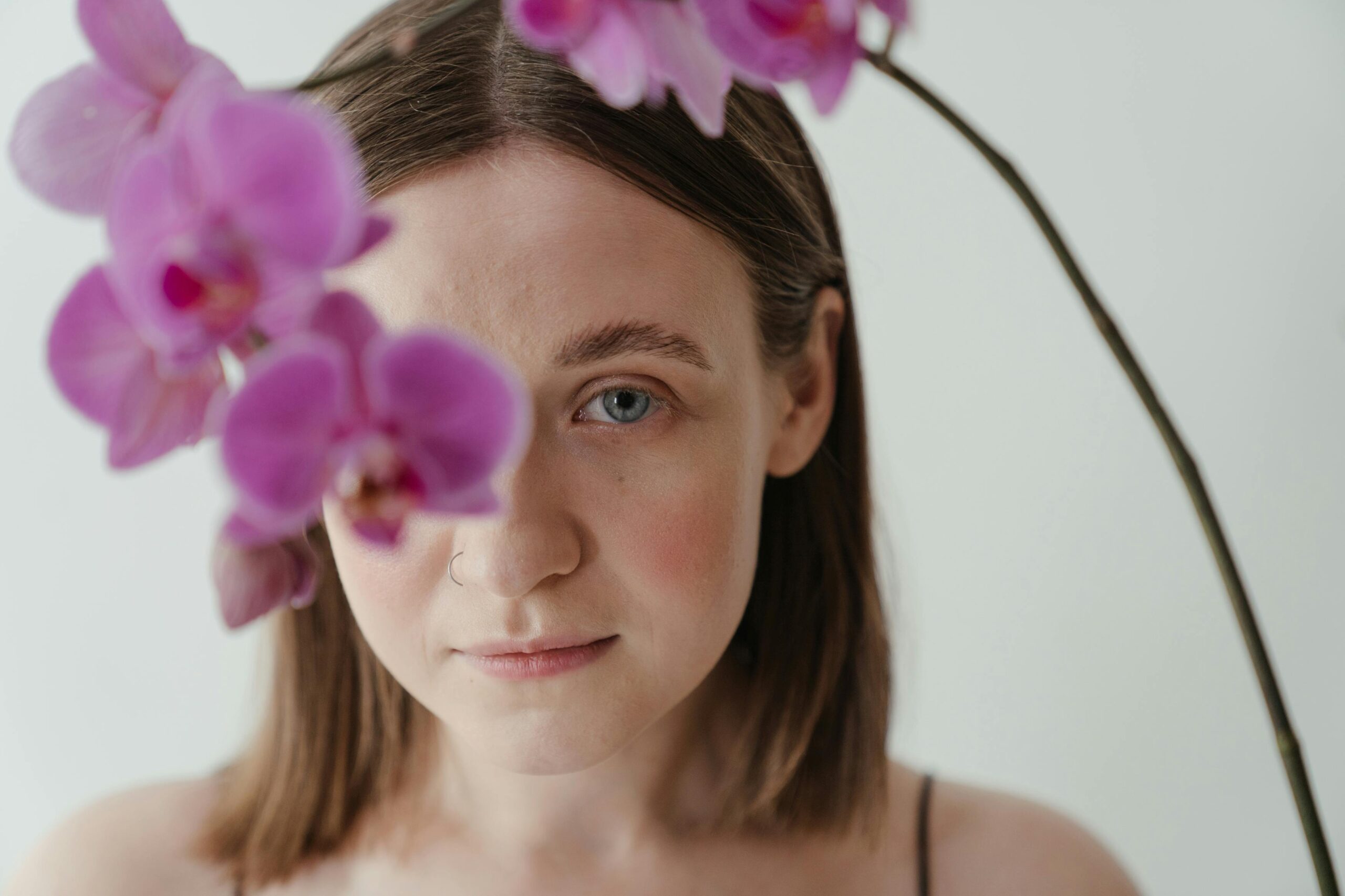 A woman posing with purple flowers | Source: Pexels