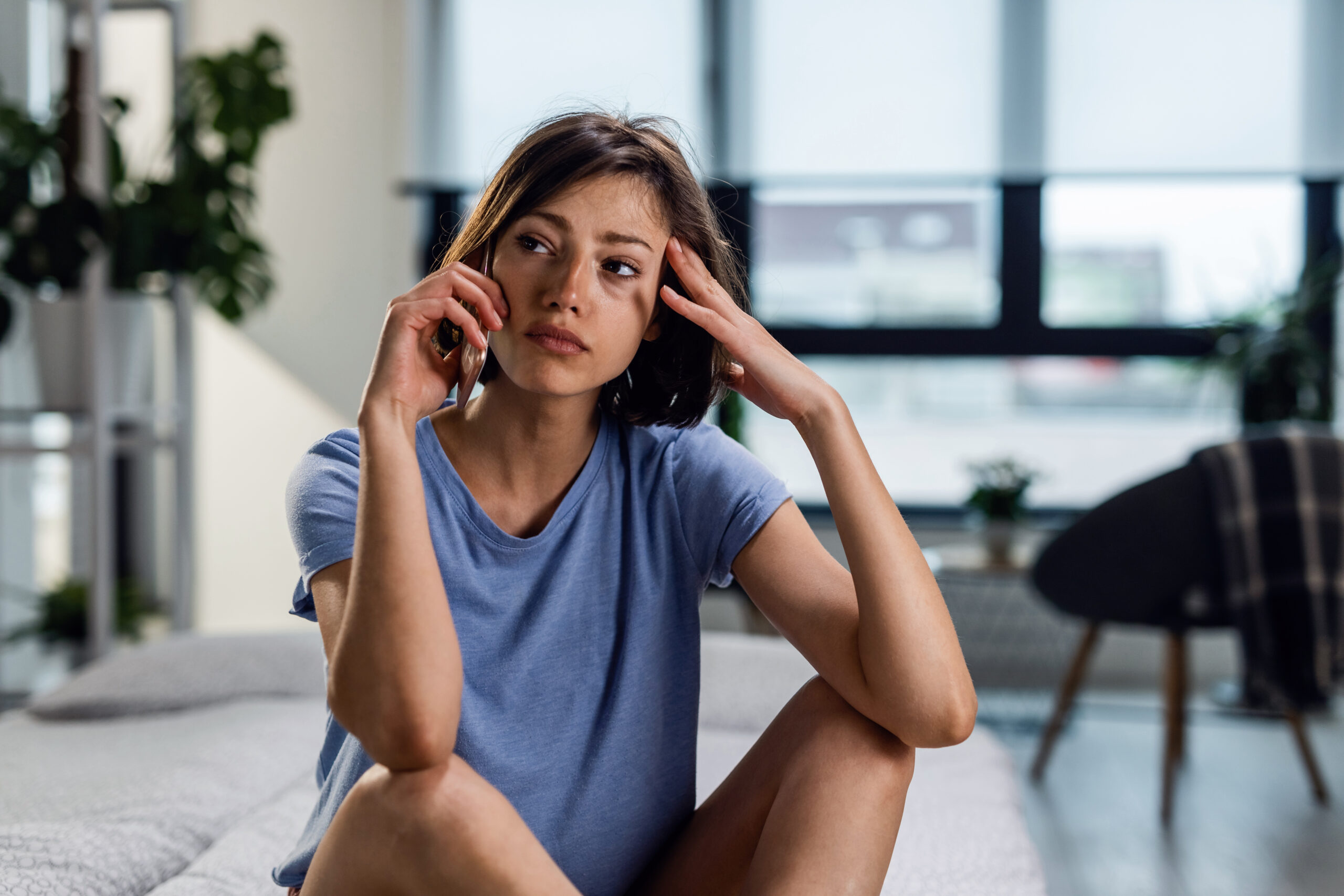 An upset and frustrated woman on a phone call | Source: Freepik