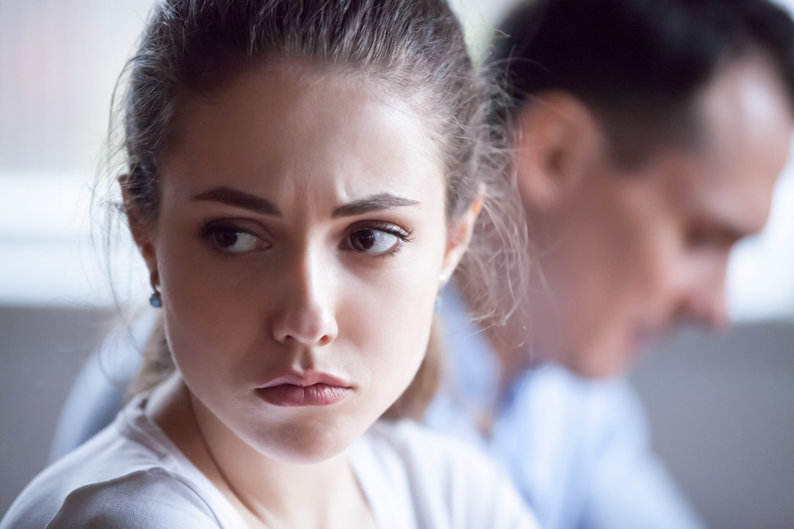 An upset woman sitting next to her husband | Source: Shutterstock