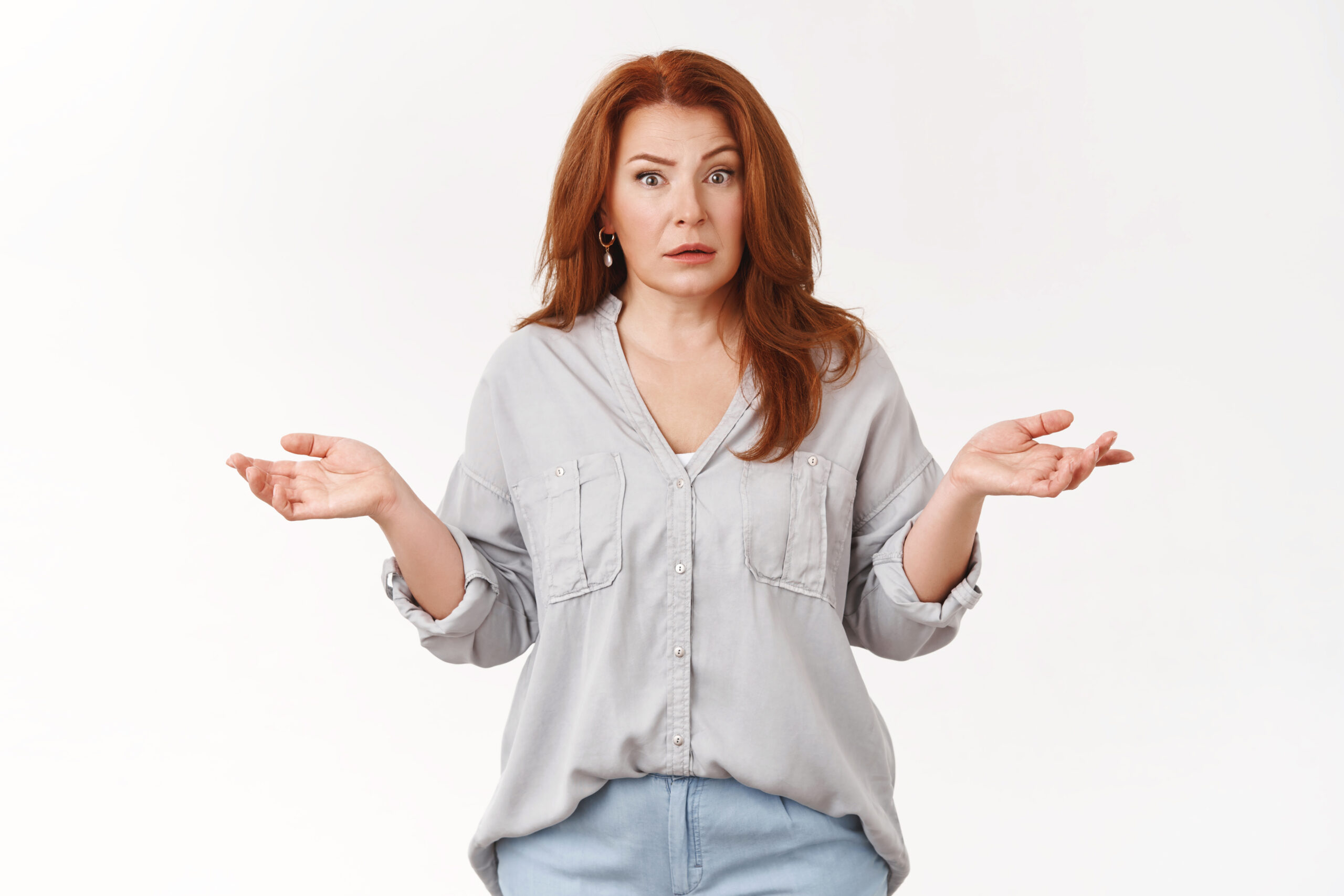 A confused woman holds her hands in the air | Source: Shutterstock