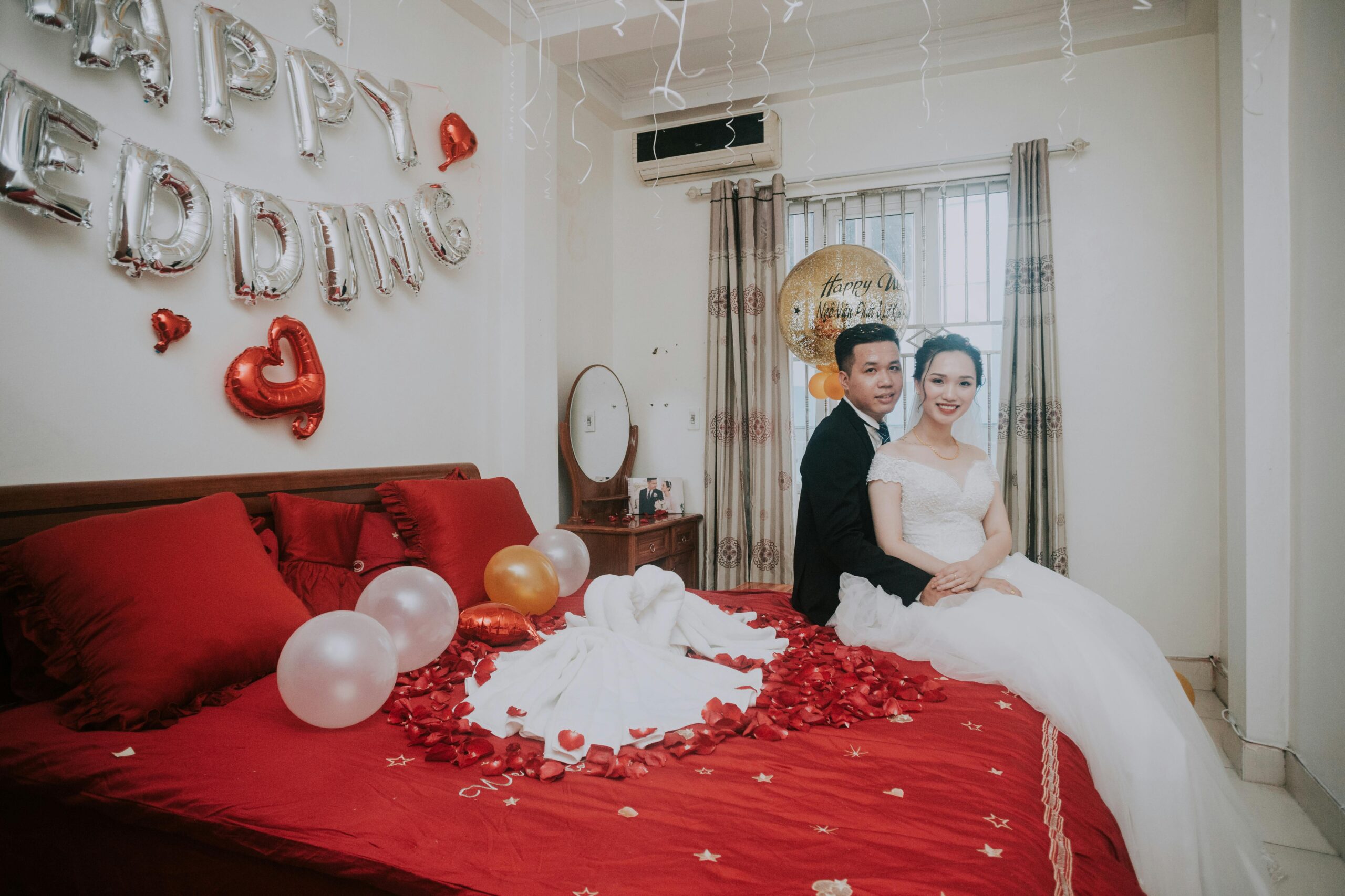 A couple pictured on the bed in a hotel room | Source: Pexels