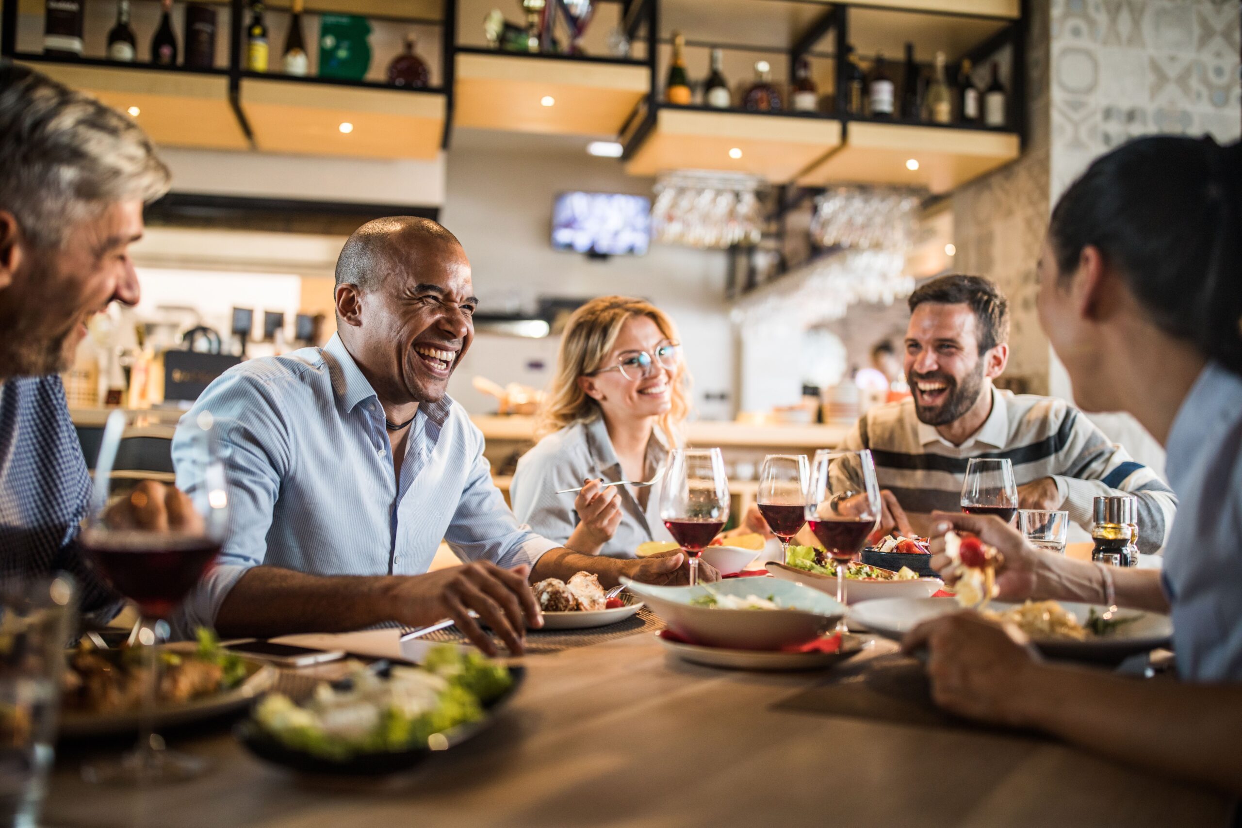 A family enjoying each others company at dinner. | Source: Getty Images