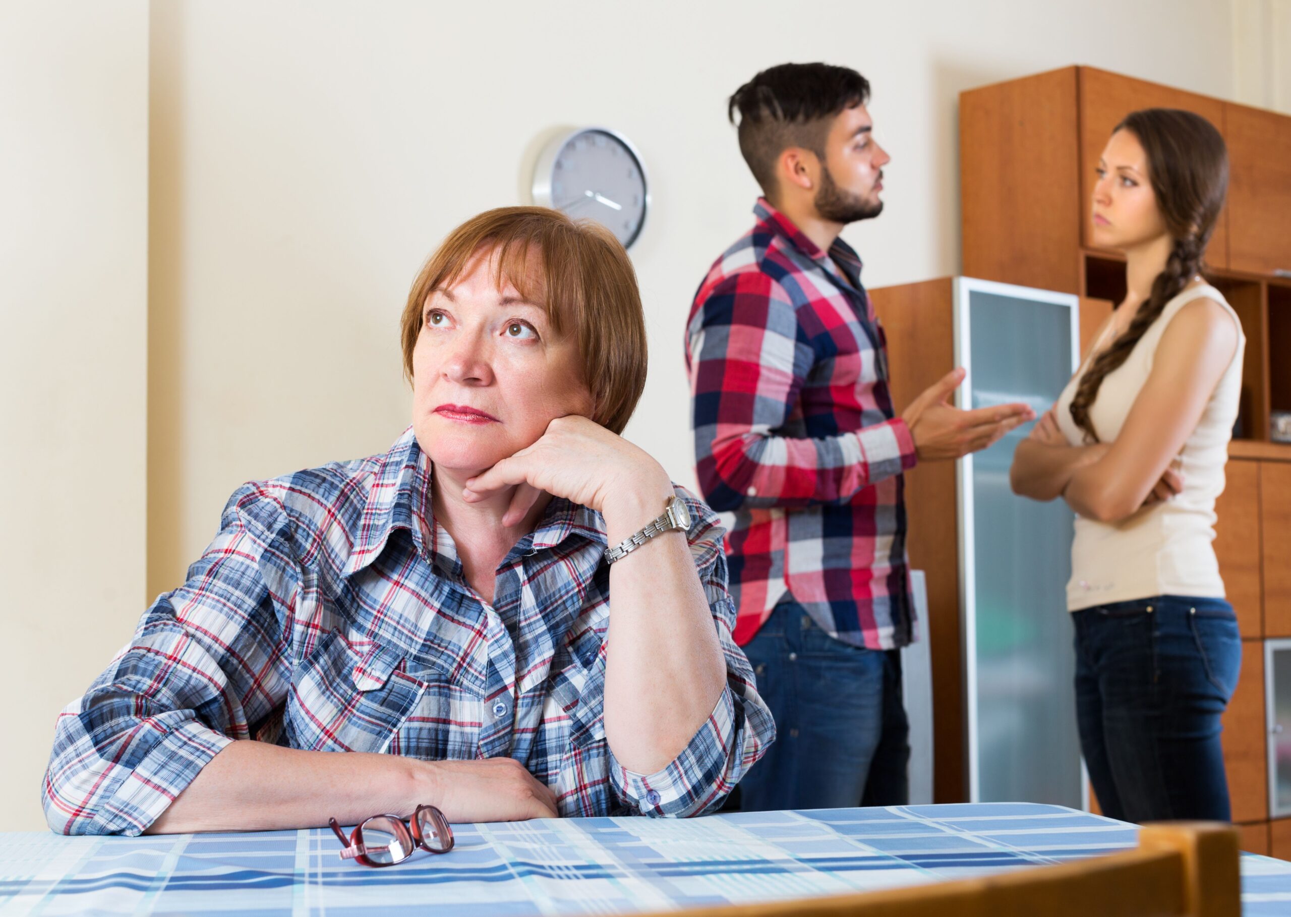 A woman looking annoyed while a couple fights behind her. | Source: Getty Images