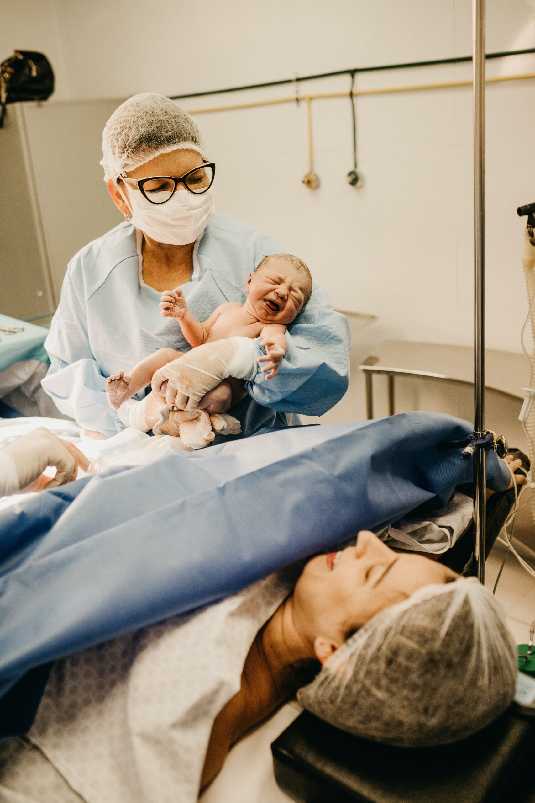 A woman carrying a baby in the theater room | Source: Pexels