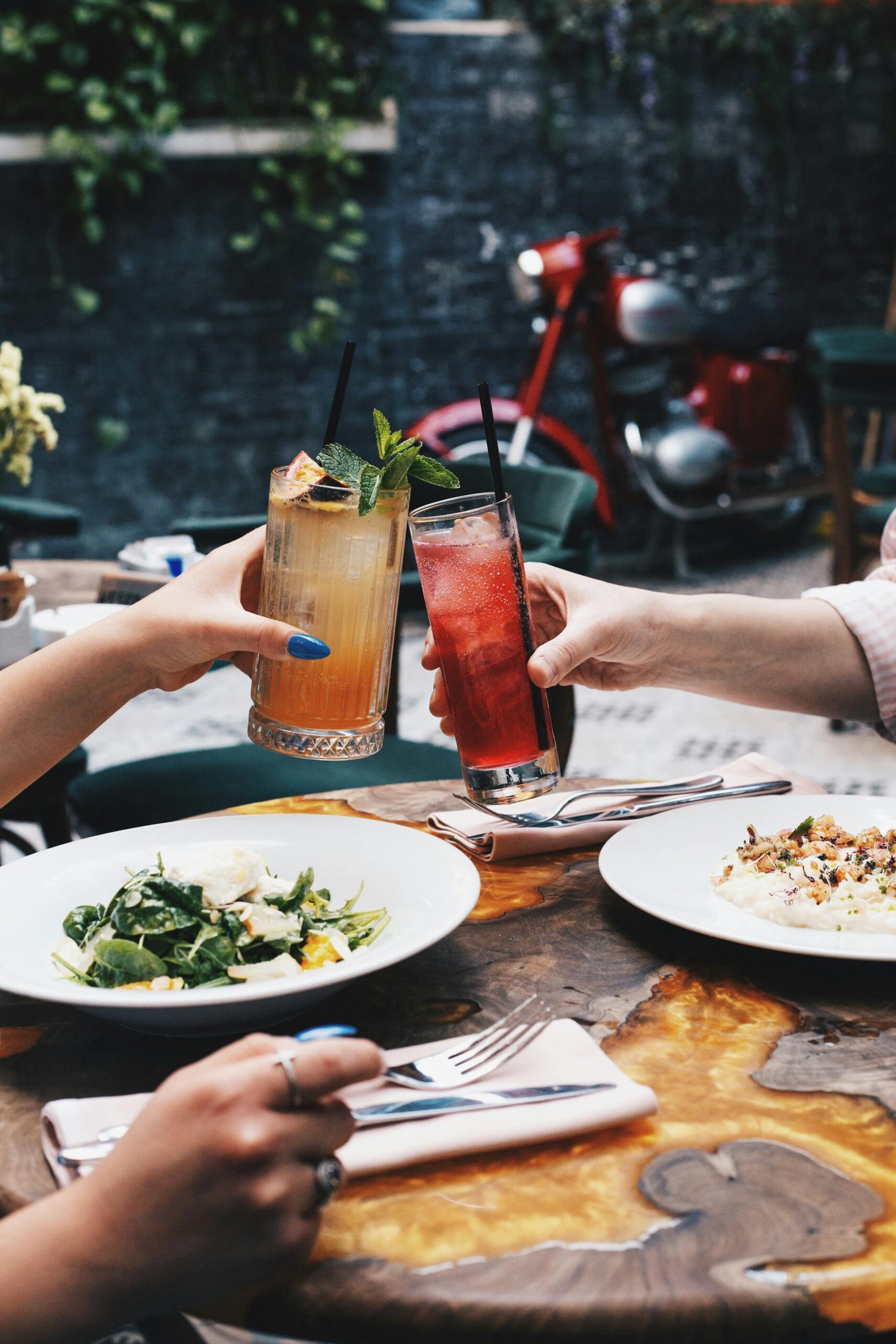 People at a restaurant cheering with iced cocktails | Source: Pexels