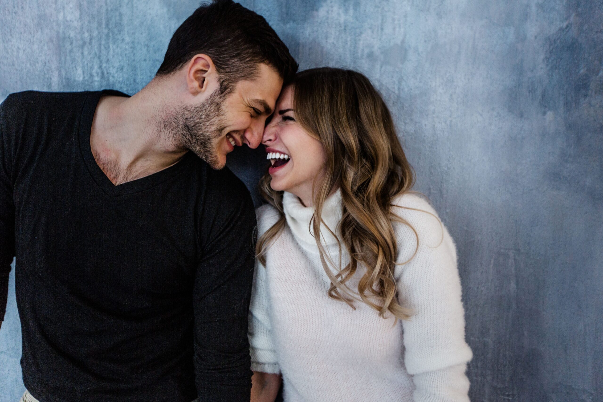 A man and woman smiling at each other with their foreheads touching | Source: Shutterstock