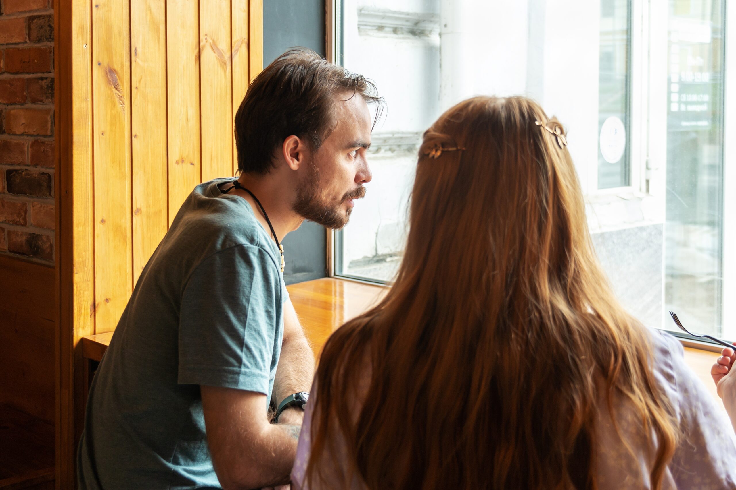 A young man looks at the window in a cafe | Source: Shutterstock