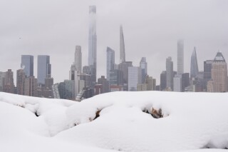 New York skyline overlooking a snow-covered landscape on the Weekhawken, N.J. waterfront, Monday, Feb. 23, 2026.