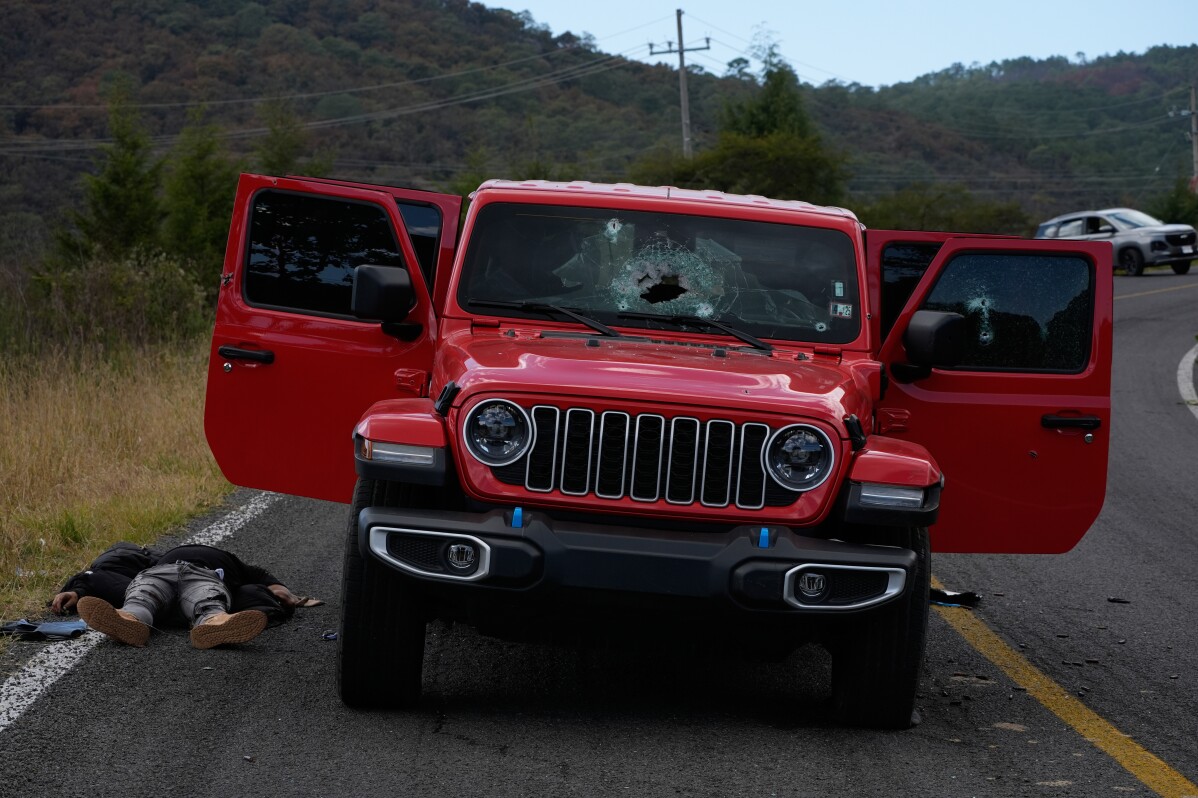 A body lies beside a bullet-riddled vehicle in Tapalpa, Mexico, a day after the Mexican army killed Jalisco New Generation Cartel leader Nemesio Oseguera Cervantes