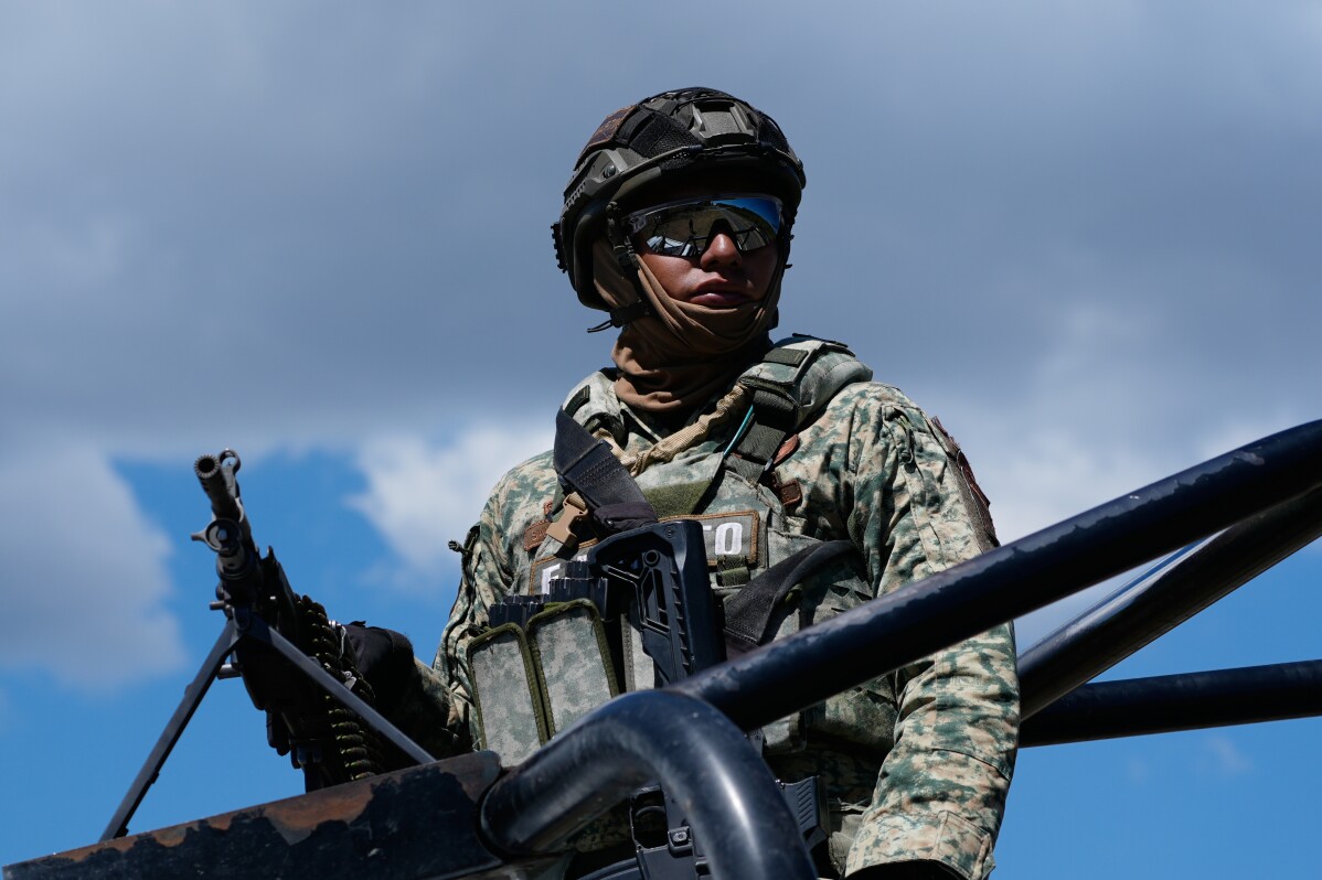 Soldiers guard a road leading to Tapalpa, Mexico