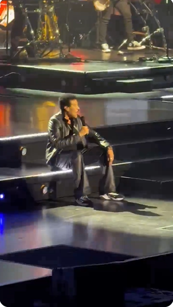 Lionel Richie sits on a set of illuminated stage steps while performing "Dancing on the Ceiling" at Grand Casino Arena in St. Paul, Minnesota, on June 25, 2026.
