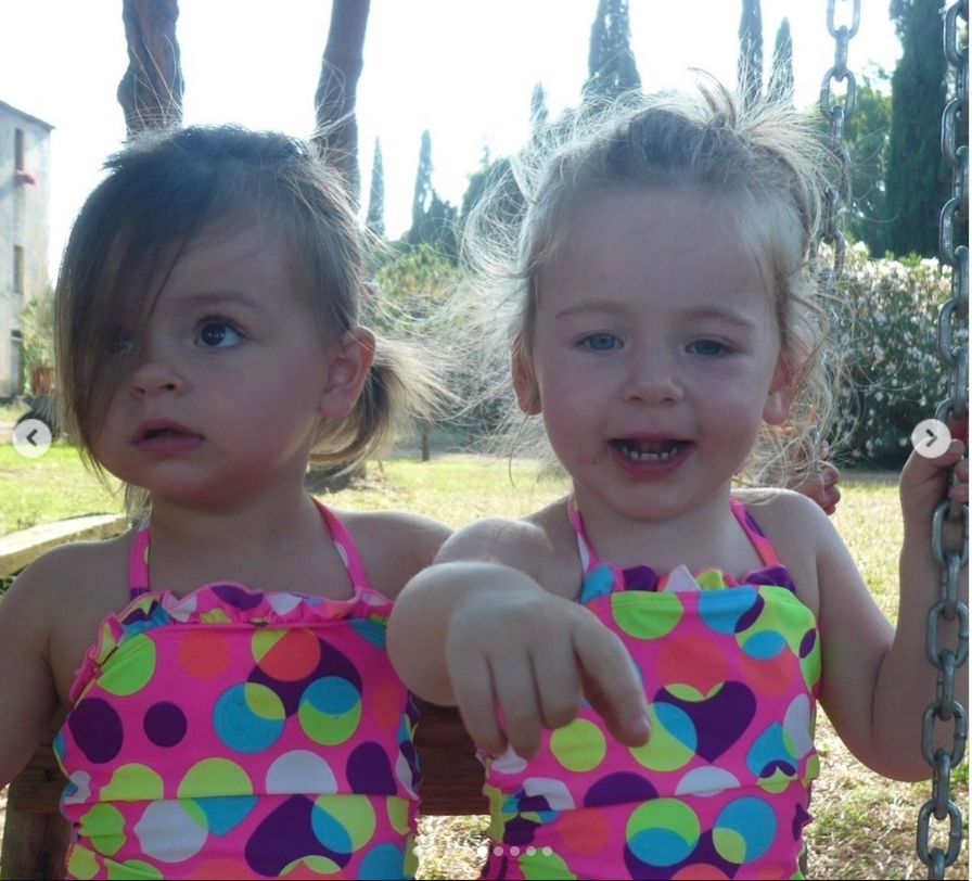 Tabitha and Marion sit on a wooden swing in matching swimsuits in another childhood memory shared by Sarah Jessica Parker on Instagram.