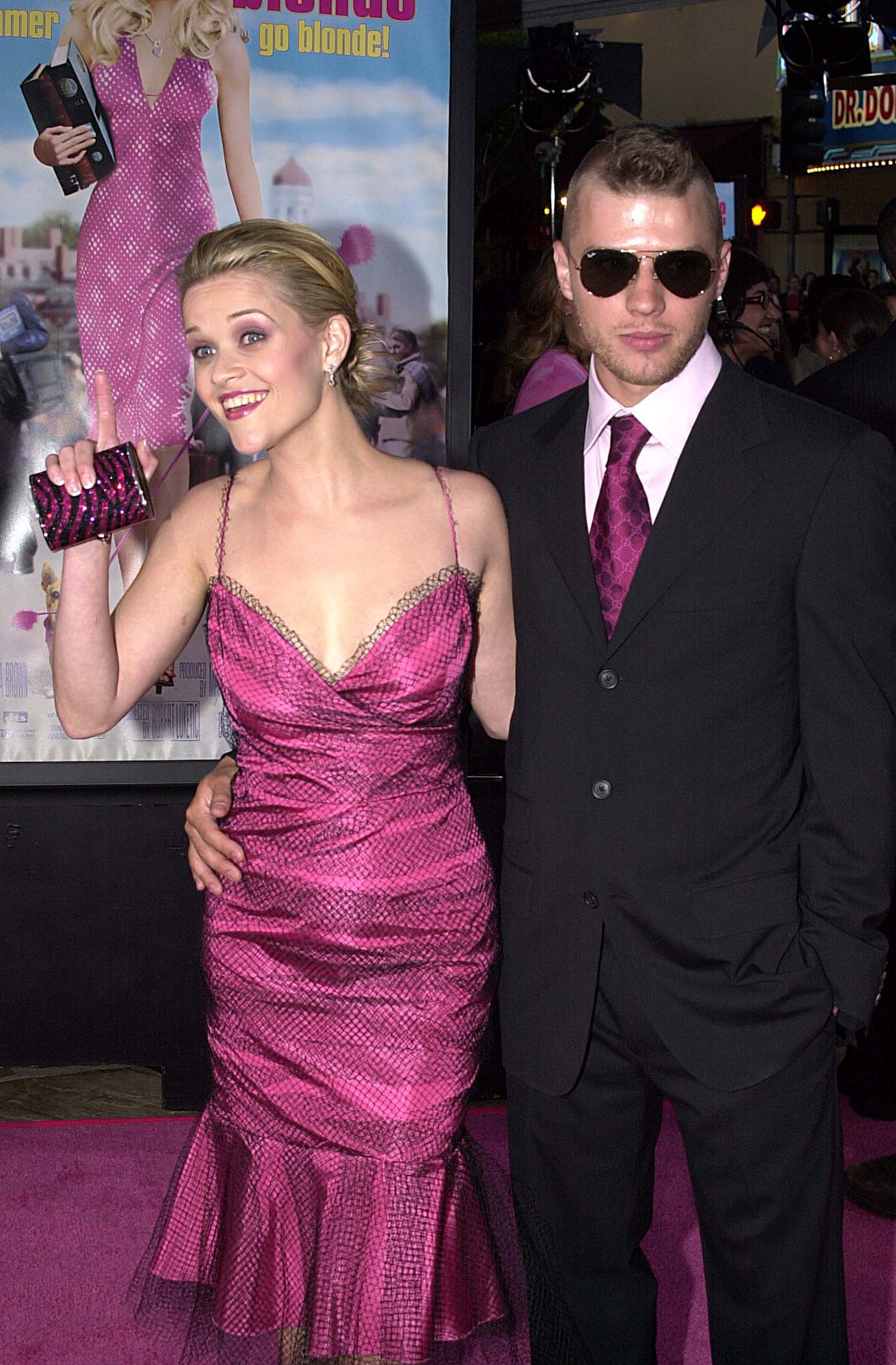 Reese Witherspoon and Ryan Phillippe attend the "Legally Blonde" premiere in 2001 at Mann Village Theatre, with her in a sparkling pink dress and him in a black suit and sunglasses.