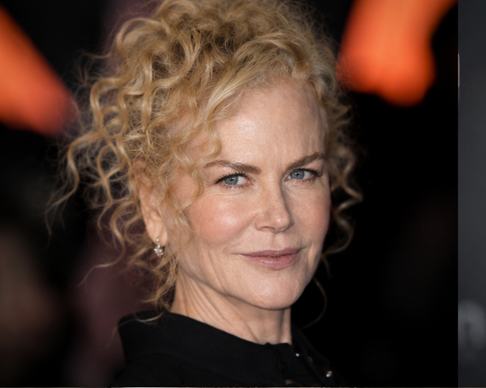Imagining a world where Kidman never touched a syringe, this look embraces her iconic, tightly coiled curls from the start of her career, paired with a soft, completely mobile complexion that shows realistic crinkling around the eyes and a natural jawline free of synthetic volume.