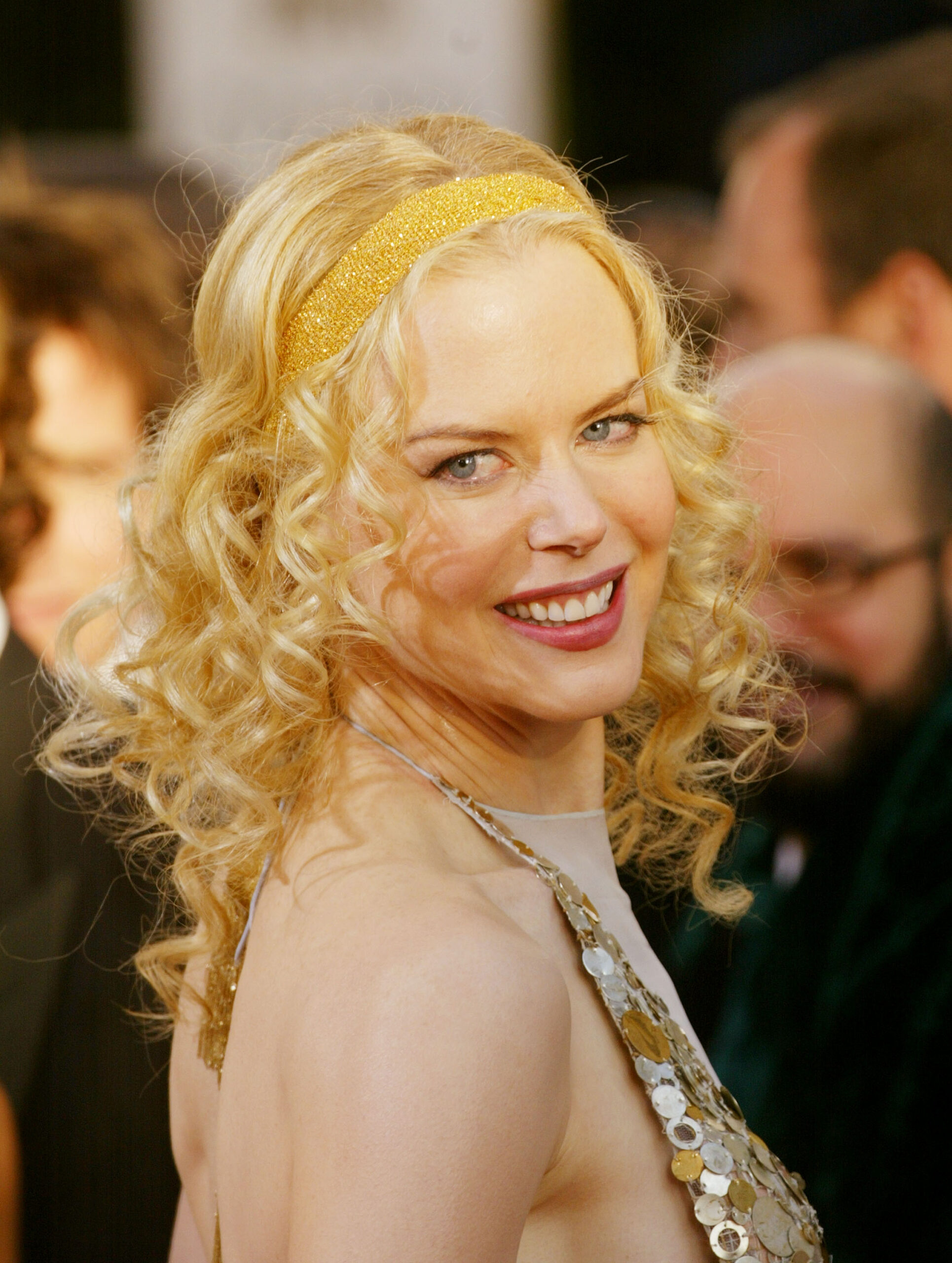 A shimmering gold headband paired with bouncy blonde curls defined her look at the 61st Annual Golden Globe Awards. Kidman paired the statement hair accessory with a metallic-disced halter gown for the January 2004 event.