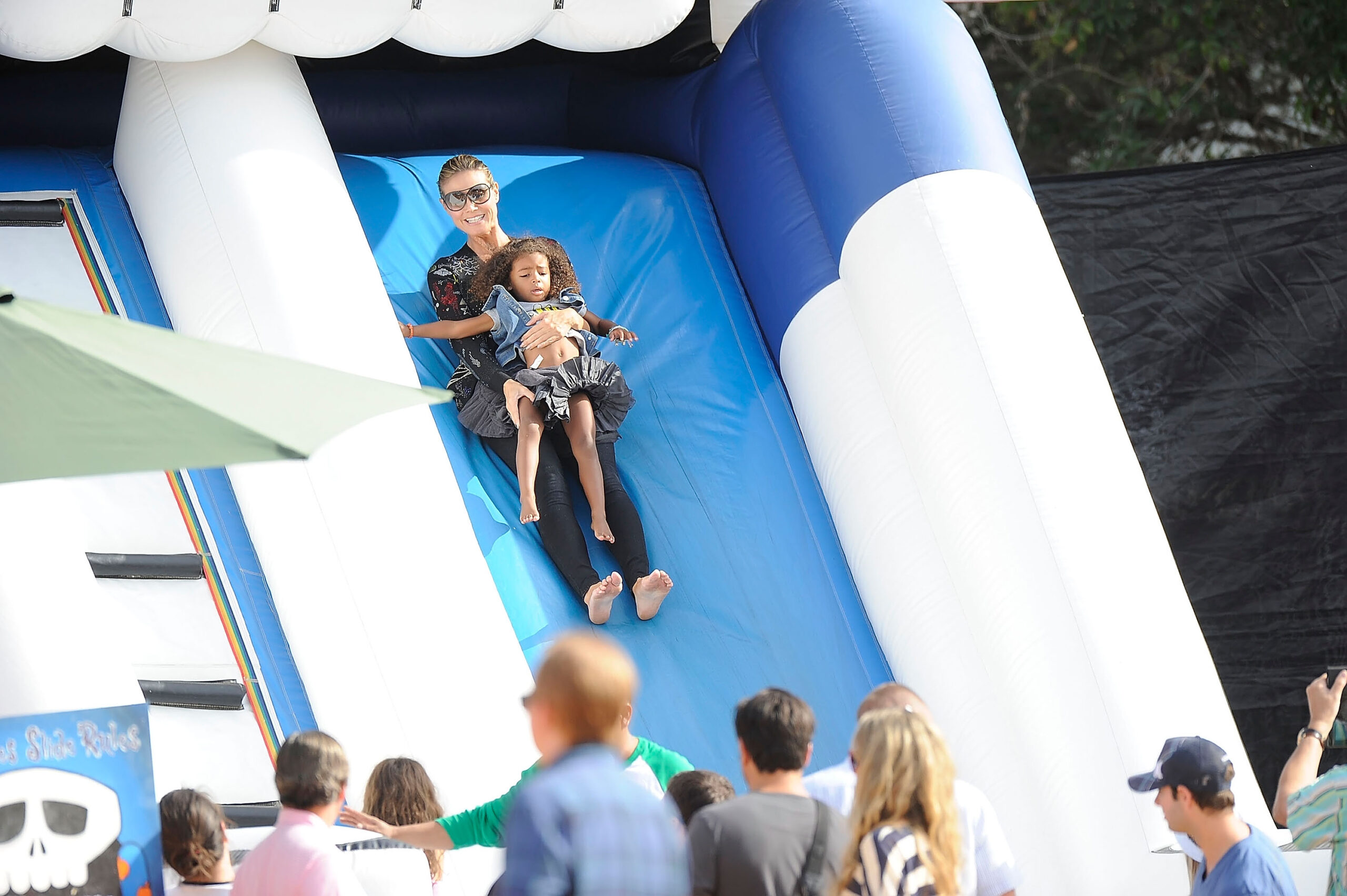 Heidi Klum seen going down a jumping castle slide with her daughter Lou Samuel at the Mr. Bones pumpkin patch on October 6, 2012, in Los Angeles, California.