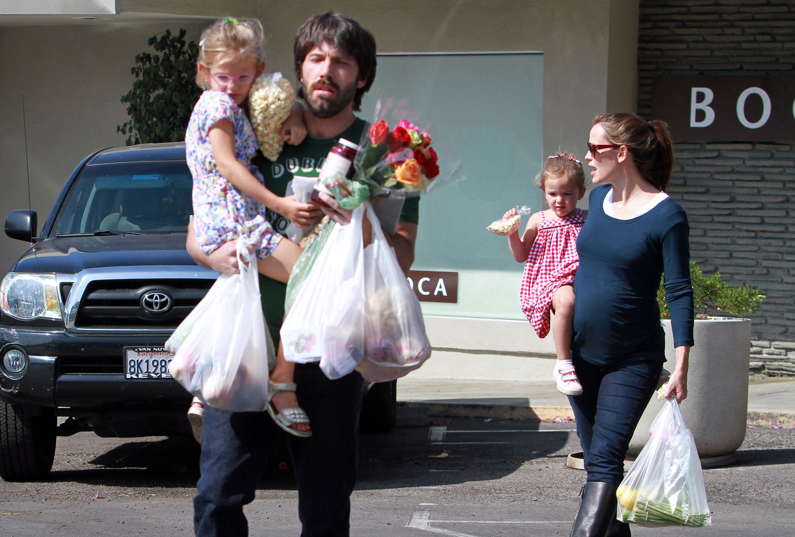 Ben Affleck and Jennifer Garner juggle groceries, flowers, and two of their children during a family outing in Los Angeles in 2011. Years later, fans wondered whether Jennifer's Father's Day tribute quietly recognized the father Ben has continued to be to their children.