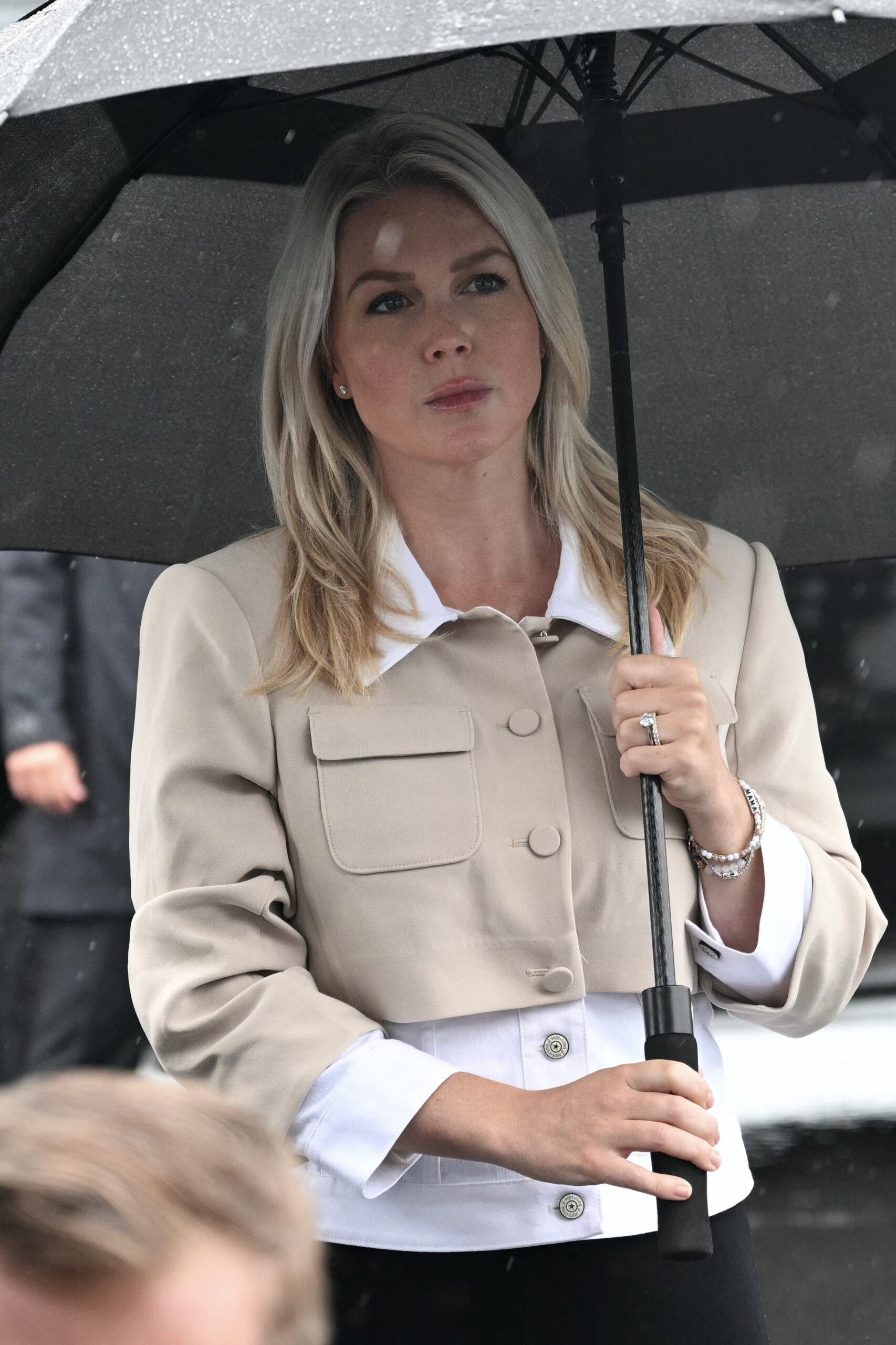She only looked serious in a few shots while holding her umbrella under the drizzling rain.
