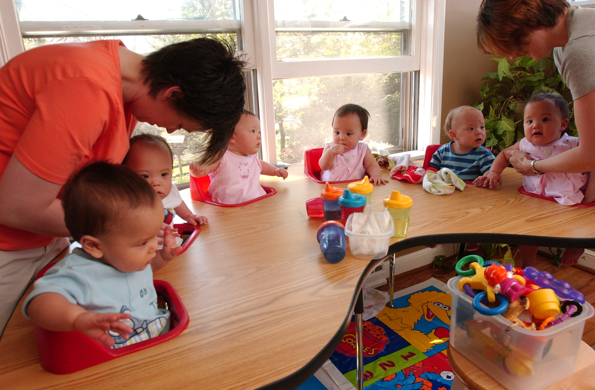 Although wholesome on air, things were a bit different behind the scenes. In this photo, Kate I. Gosselin and Angie S. Crawl got Kate's sextuplet sons and daughters ready to eat lunch at Kate's house in Wyomissing on April 19, 2005, in Wyomissing, Pennsylvania.