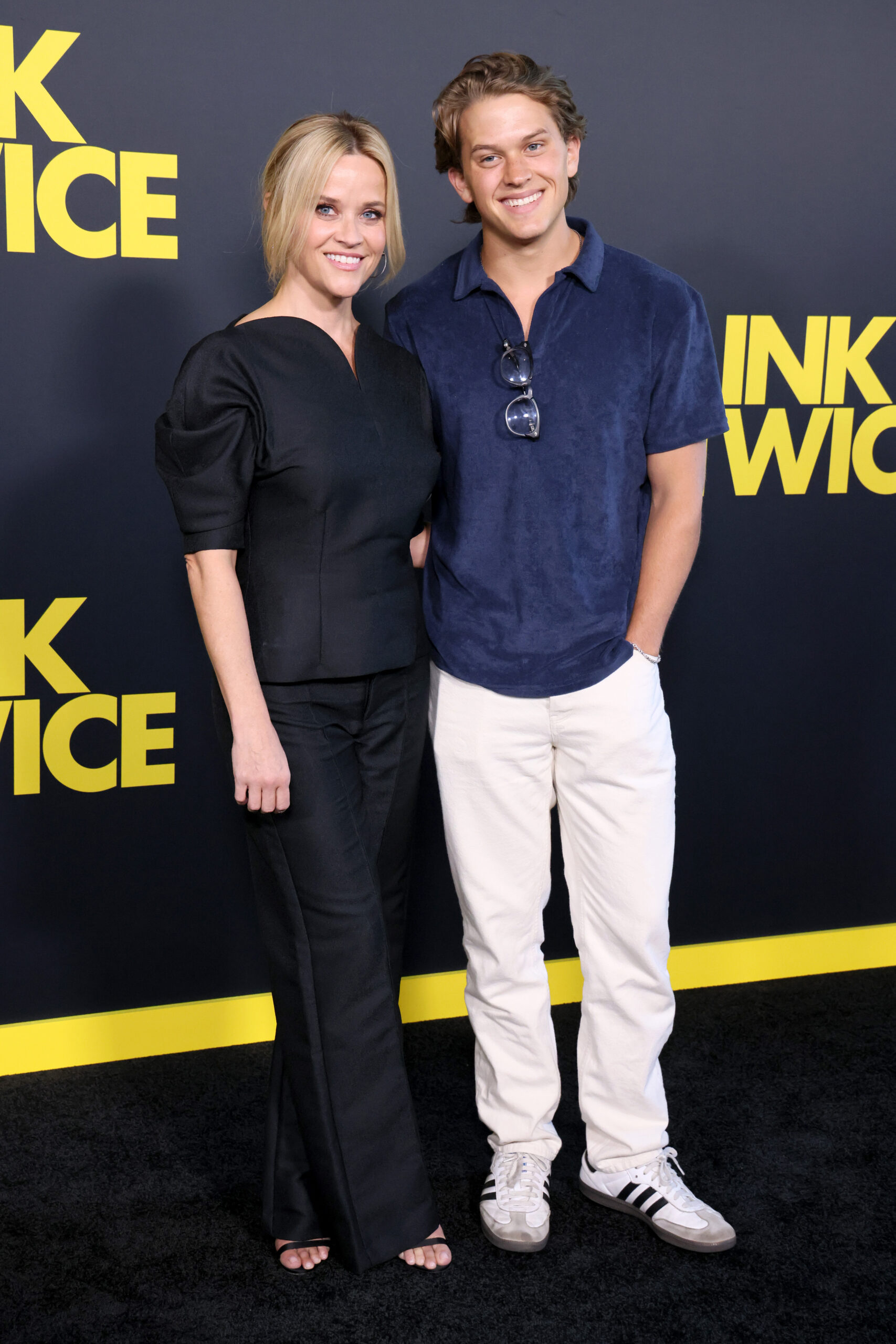 Reese Witherspoon and Deacon Phillippe attend the Los Angeles premiere of Amazon MGM Studios' "Blink Twice," smiling together against the film's bold black-and-yellow backdrop.