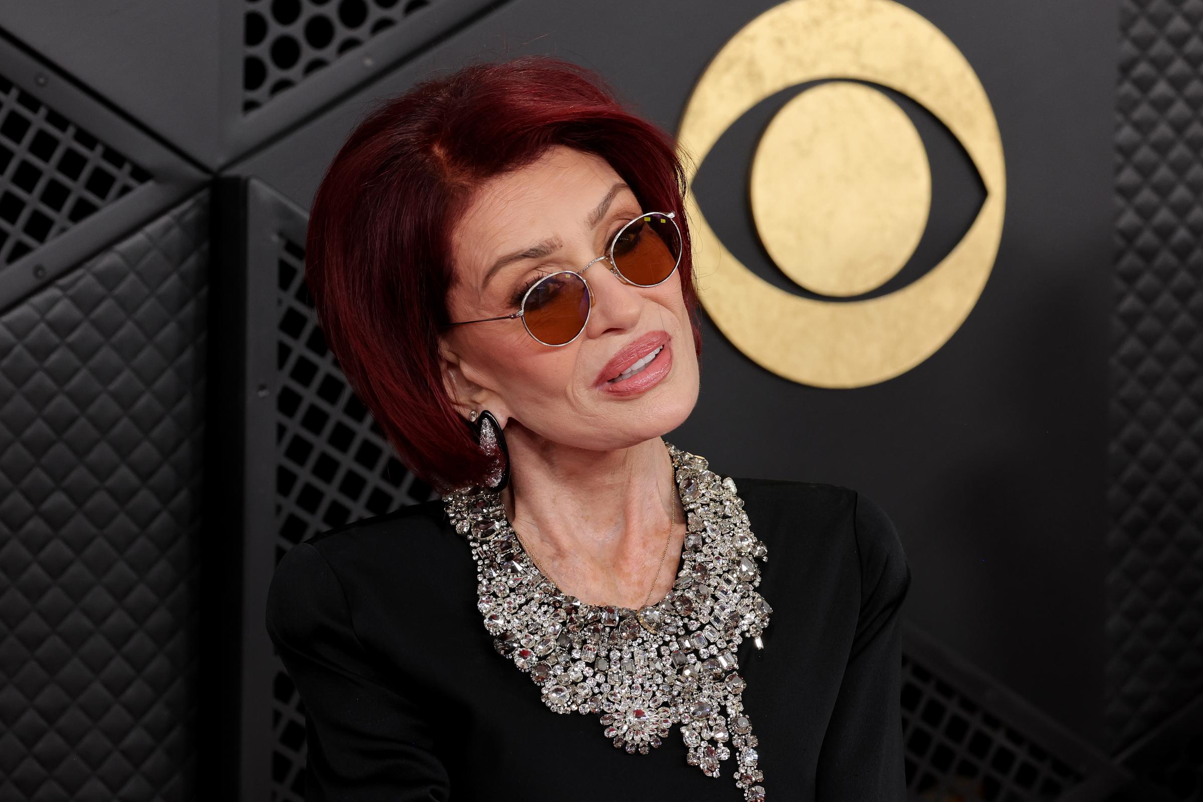 Sharon Osbourne is pictured at the 68th GRAMMY Awards at Crypto.com Arena on February 1, 2026. Months later, she disclosed that an unexpected visit kept her from attending a tribute honoring her late husband.
