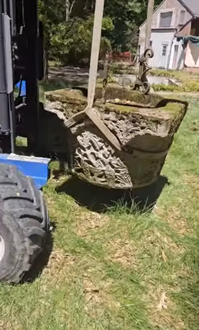 Workers salvaged this historic stone wellhead from Richard Gere's former Connecticut estate before the property was demolished. Although the house was later torn down, preservation efforts saved several architectural features connected to the estate's history.
