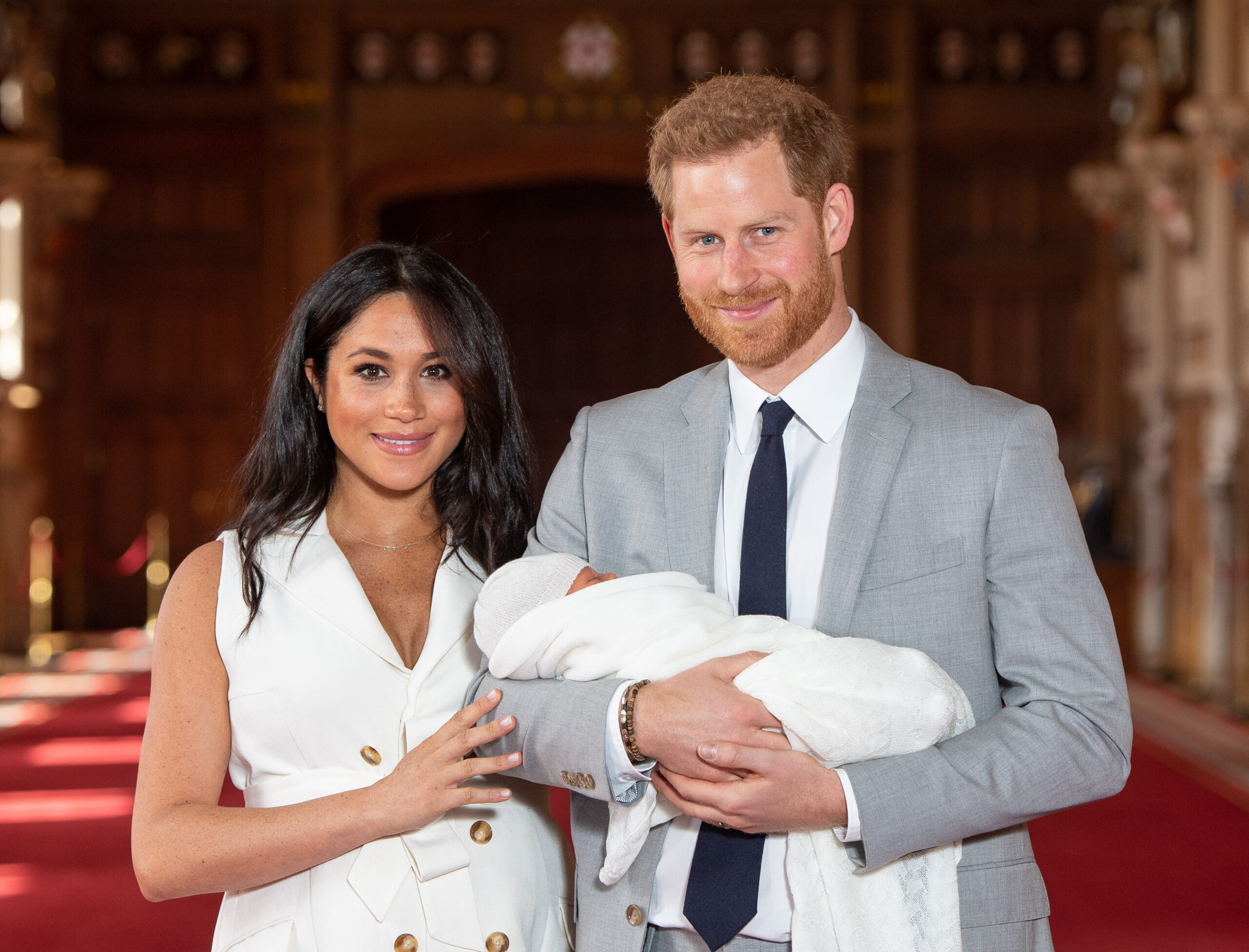 Prince Harry, Duke of Sussex and Meghan, Duchess of Sussex, pose with their newborn son Archie Harrison Mountbatten-Windsor during a photocall in St George's Hall at Windsor Castle on May 8, 2019 in Windsor, England