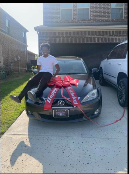 Karmelo Anthony sits on a Lexus adorned with a red gift bow in a photo taken before the events that led to his murder conviction.