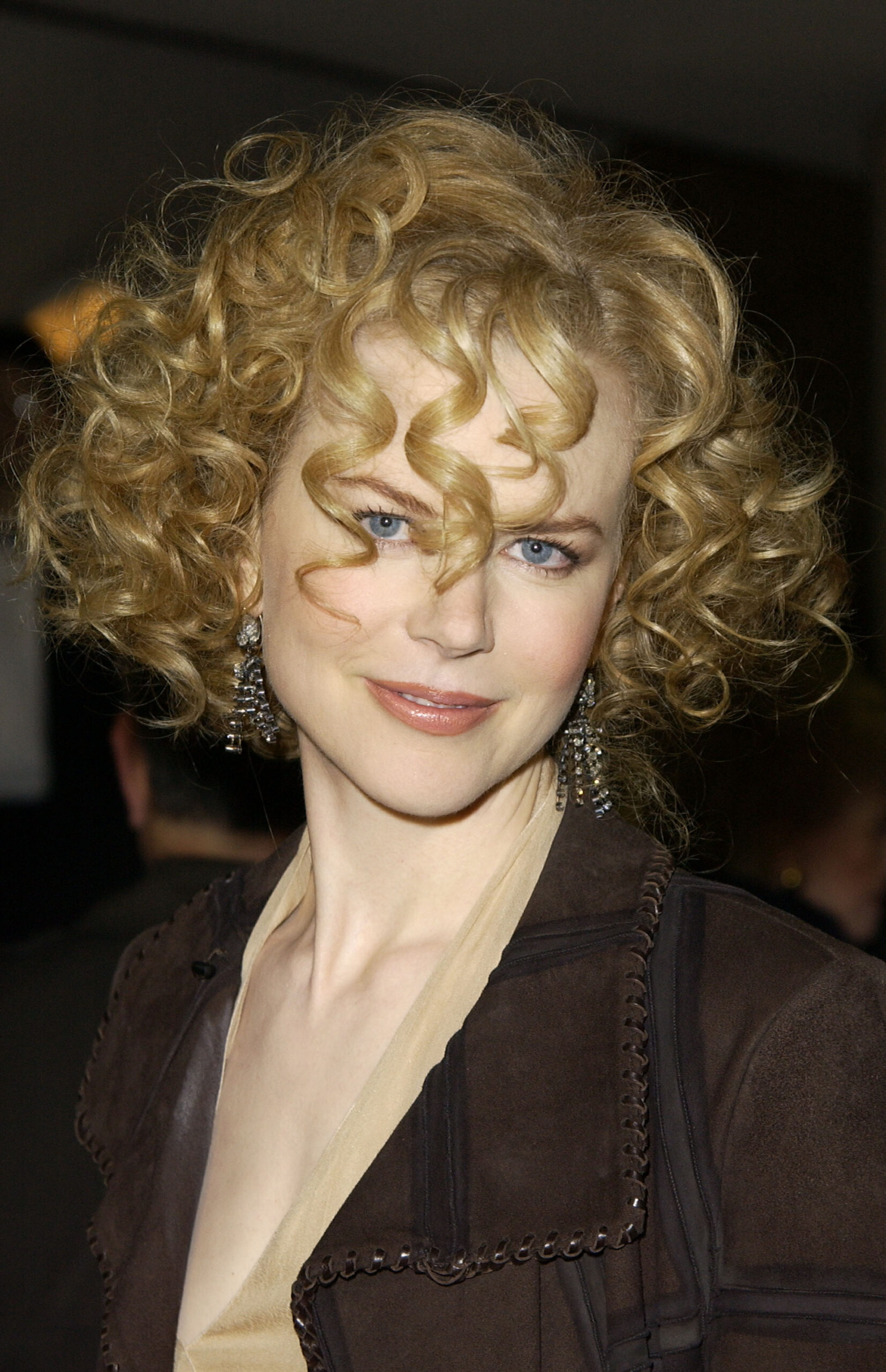 Volume-heavy blonde curls took center stage in December 2002 for the Westwood world premiere of "The Hours." Captured in outside Mann's National Theater, her distinct hairstyle complemented a neutral-toned jacket and drop earrings.