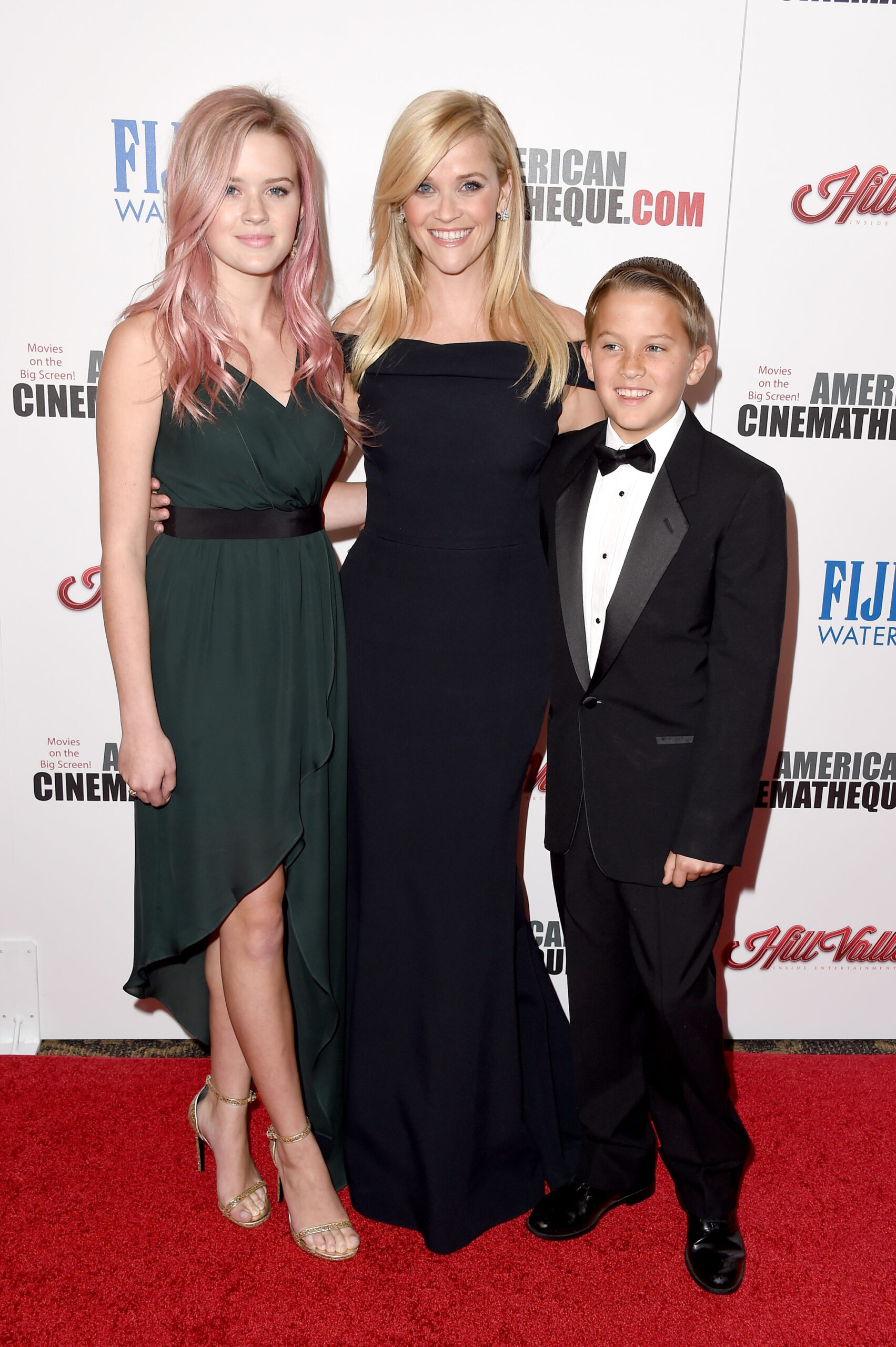Reese Witherspoon poses with Ava Phillippe and Deacon Phillippe at the American Cinematheque Award ceremony honoring her, standing between her children in a sleek black gown.