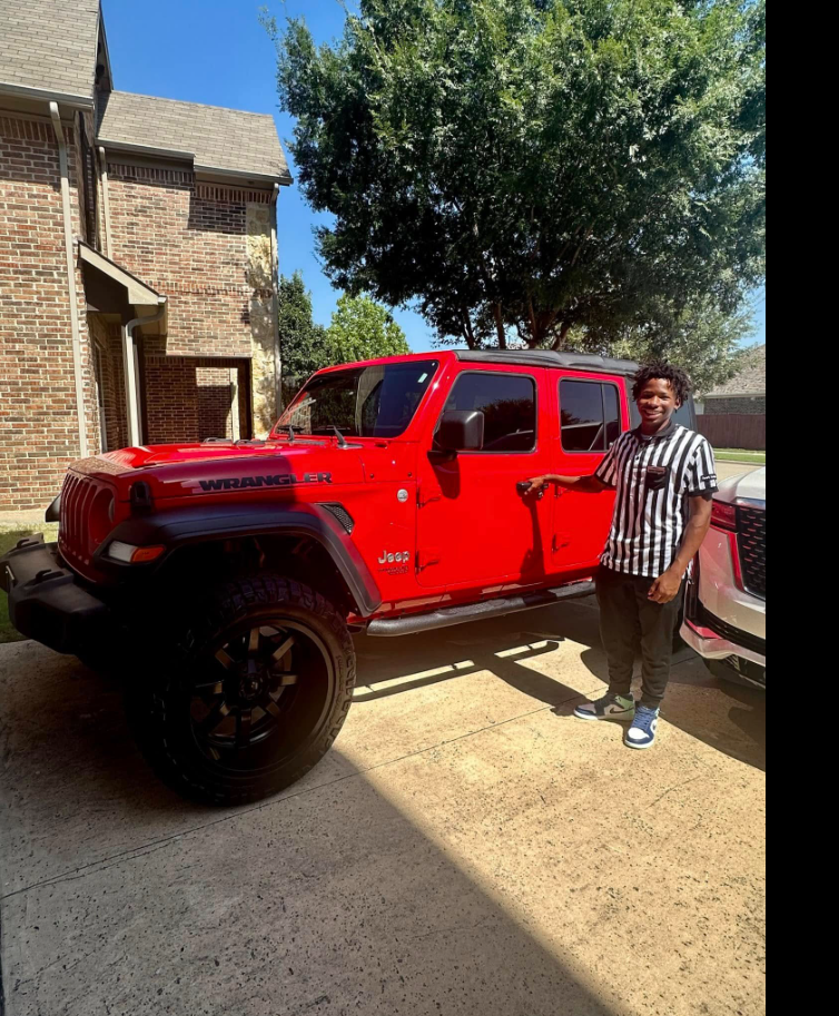 Karmelo Anthony poses next to a red Jeep Wrangler before the fatal stabbing case that would later place him at the center of national headlines.