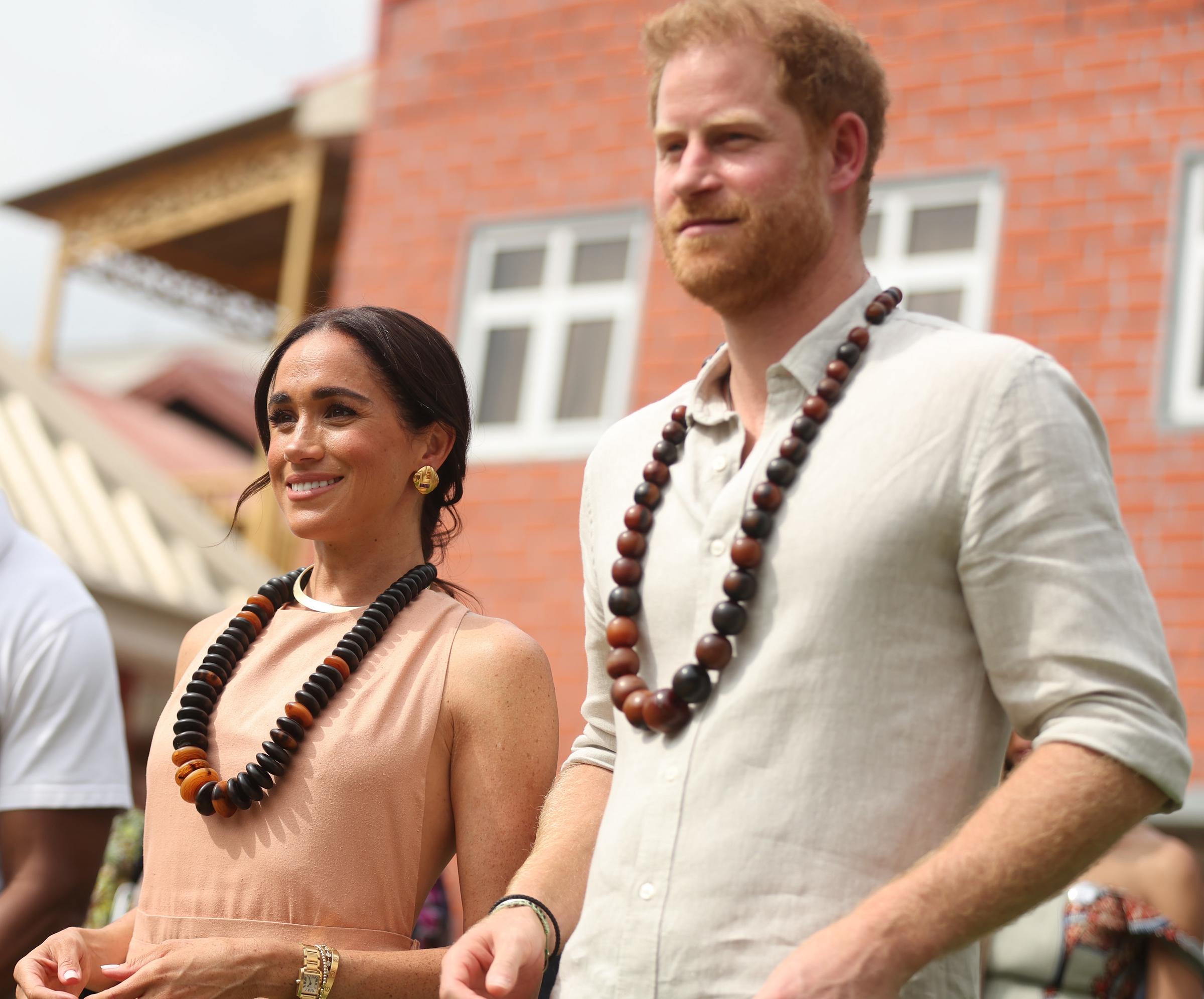 Duke of Sussex Prince Harry (R) his wife Meghan Markle (L), Duchess of Sussex, visit the Lightway Academy in Abuja, Nigeria as part of celebrations of Invictus Games anniversary on May 10, 2024