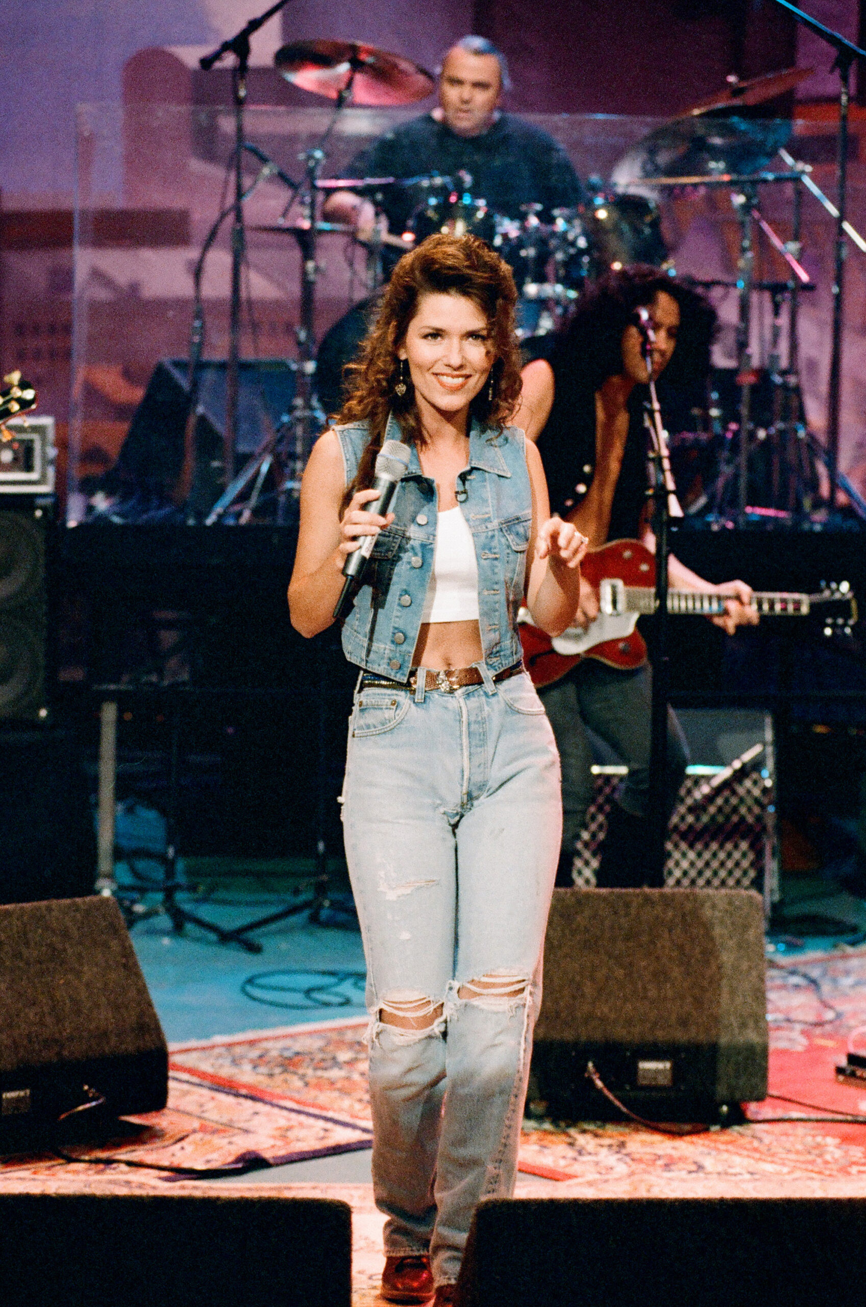 Twain's denim-and-crop-top era captured the effortless '90s charm that helped make her one of country music's most recognizable crossover figures. Long before the recent debate over her stage style, she was already mixing casual fashion with bold performance confidence.