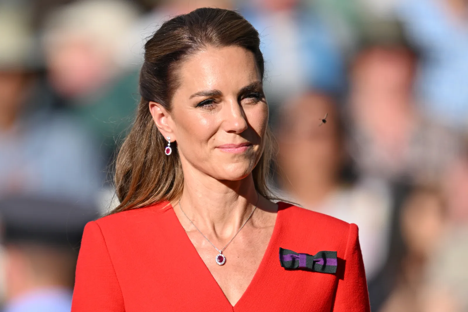A close-up of Catherine's outfit makes the purple-and-green Wimbledon bow easy to spot. The ribbon has become a familiar feature of her Championships wardrobe and reflects her connection to the tournament.