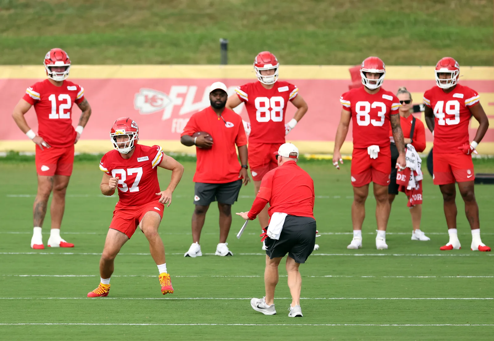 Travis Kelce works through a drill during the Chiefs' first training camp practices as attention surrounding his offseason gives way to preparations for the new NFL season.
