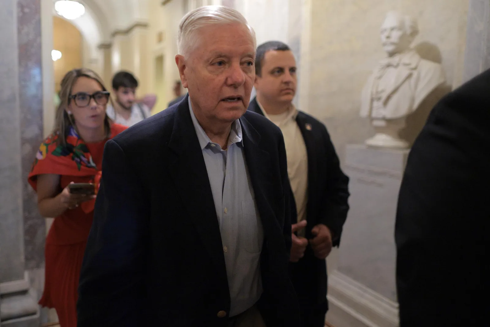 Newly published images show Lindsey Graham being carted out of his residence while surrounded by Emergency Medical Service workers administering first aid.