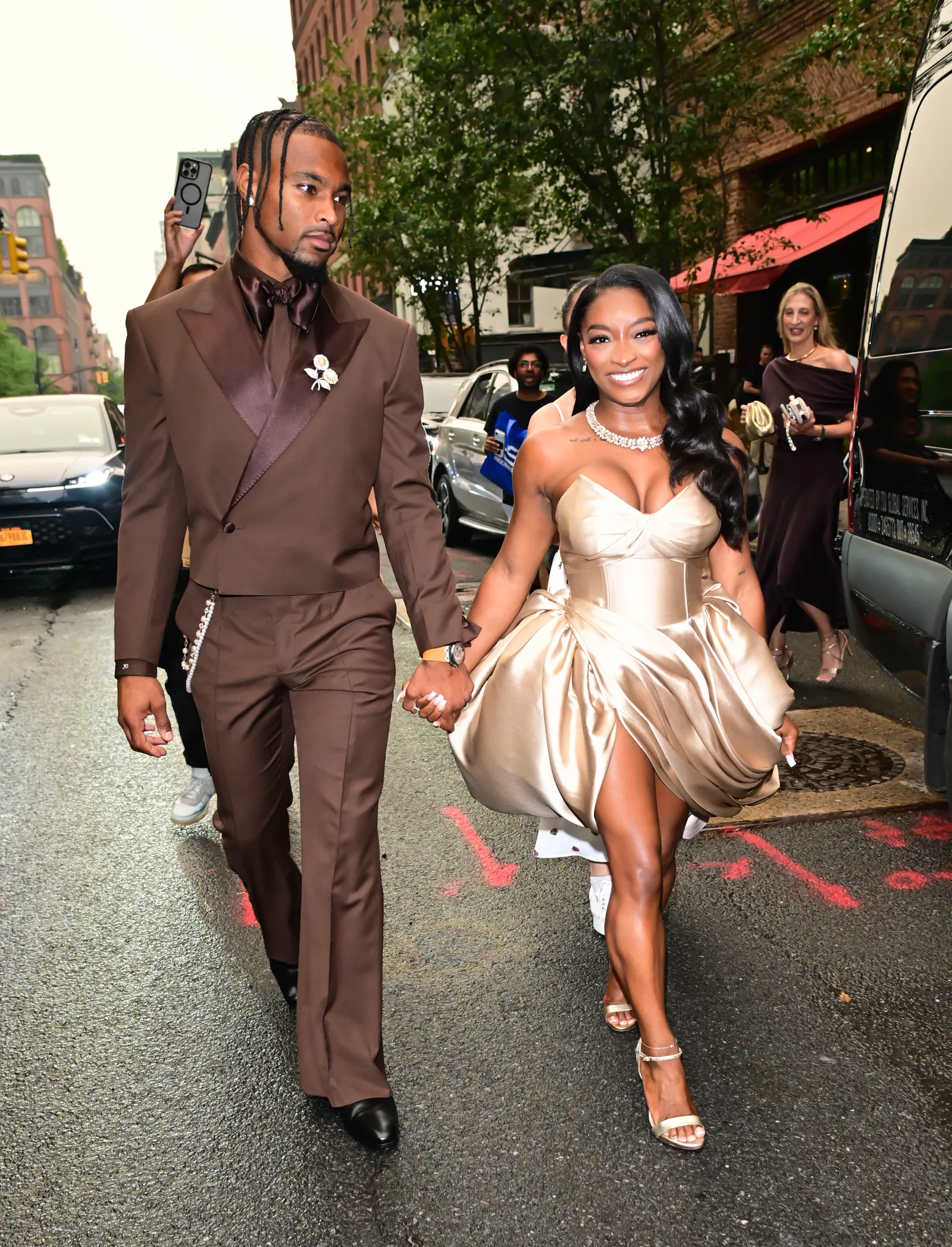 Away from the backdrop, the couple's coordinated outfits remained just as striking as they walked through New York City hand in hand. The candid image offered a different perspective from the red carpet and showed the pair interacting beyond the brief viral clip.