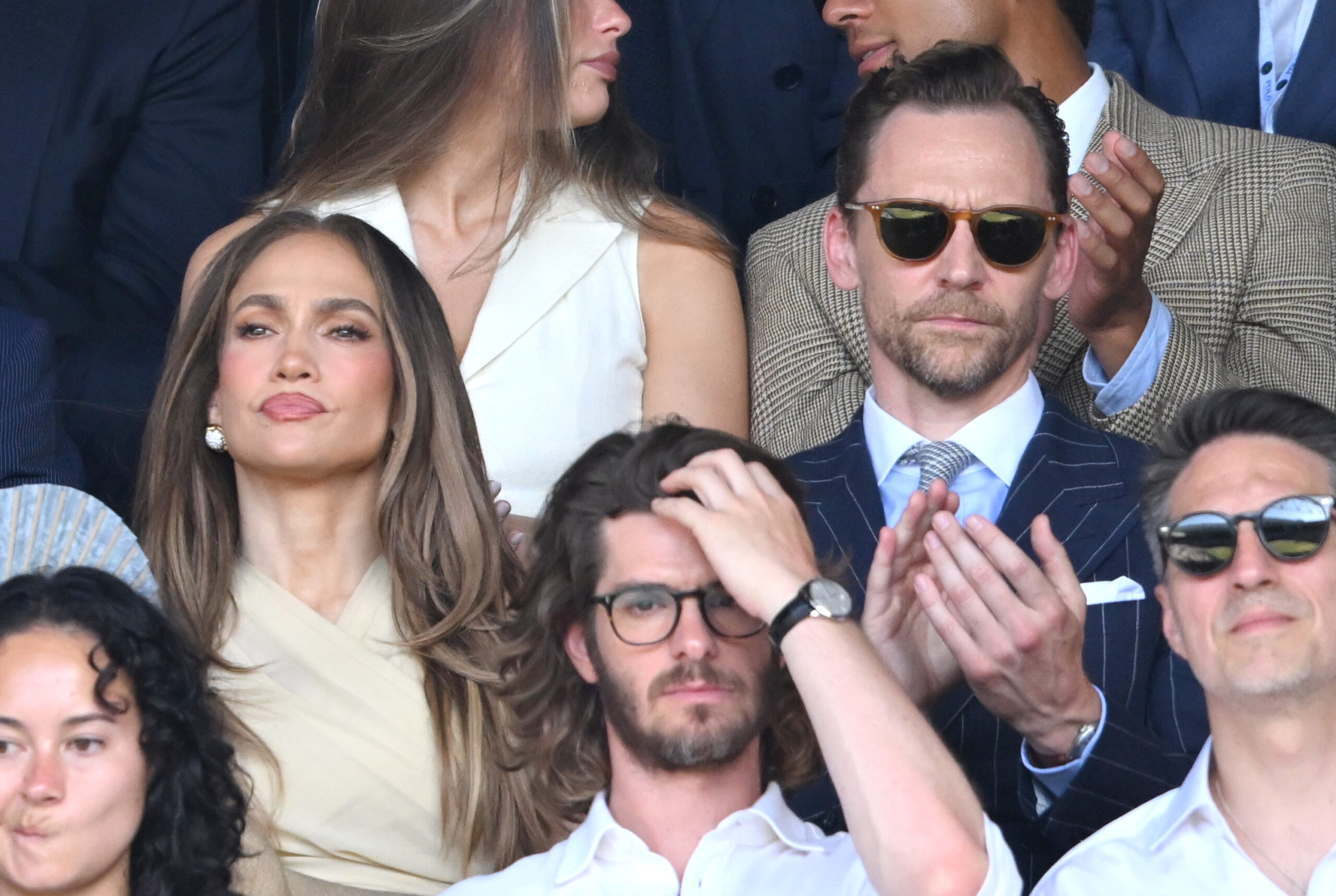 Lopez attended the men's singles final in a cream Ralph Lauren ensemble that balanced understated tailoring with unmistakable star power. Without the controversial accessory, attention shifted to her polished styling and signature caramel-toned waves.