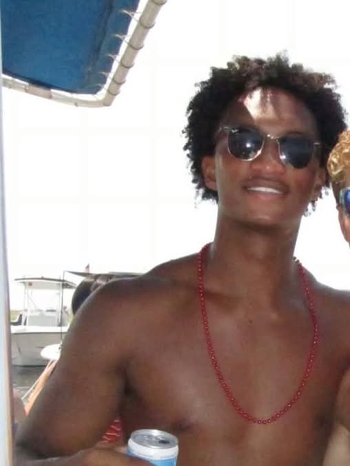 In what would become one of his final photos, Nolan smiles aboard a boat, sunglasses on and a red beaded necklace around his neck — the same easy grin friends and family would remember him by.