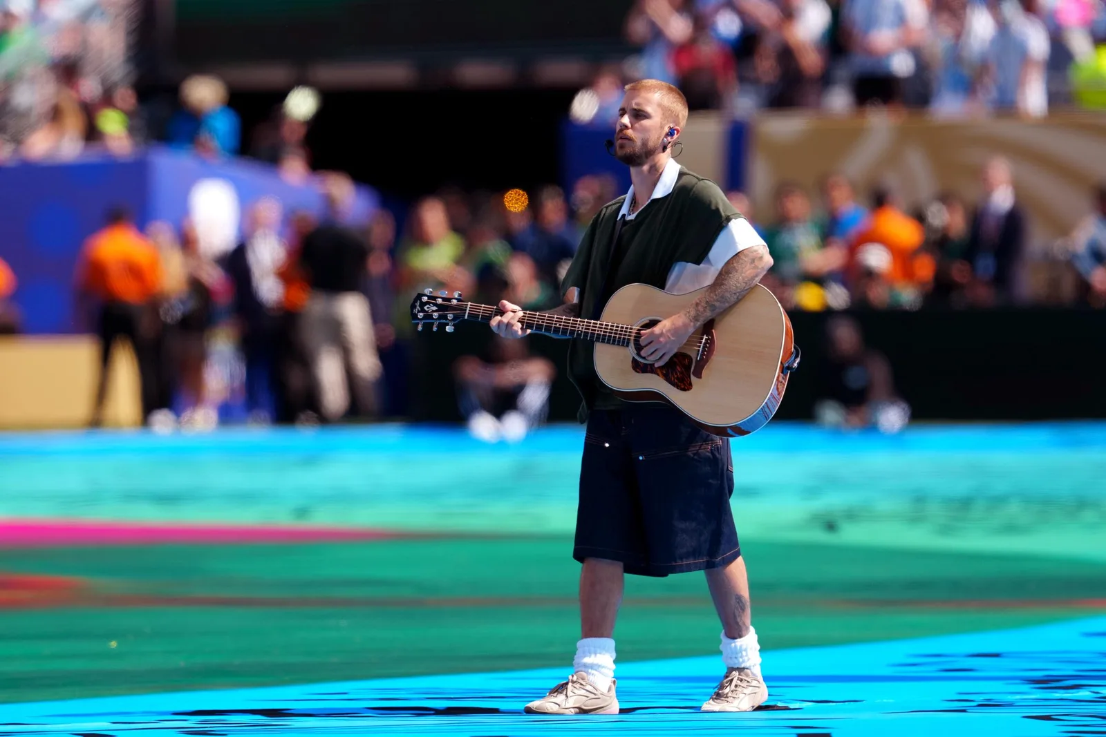 Justin Bieber took a more stripped-back approach, performing with an acoustic guitar in a set that emphasized vocals over elaborate staging. The contrast in presentation became one of the most talked-about aspects of FIFA's inaugural halftime show.