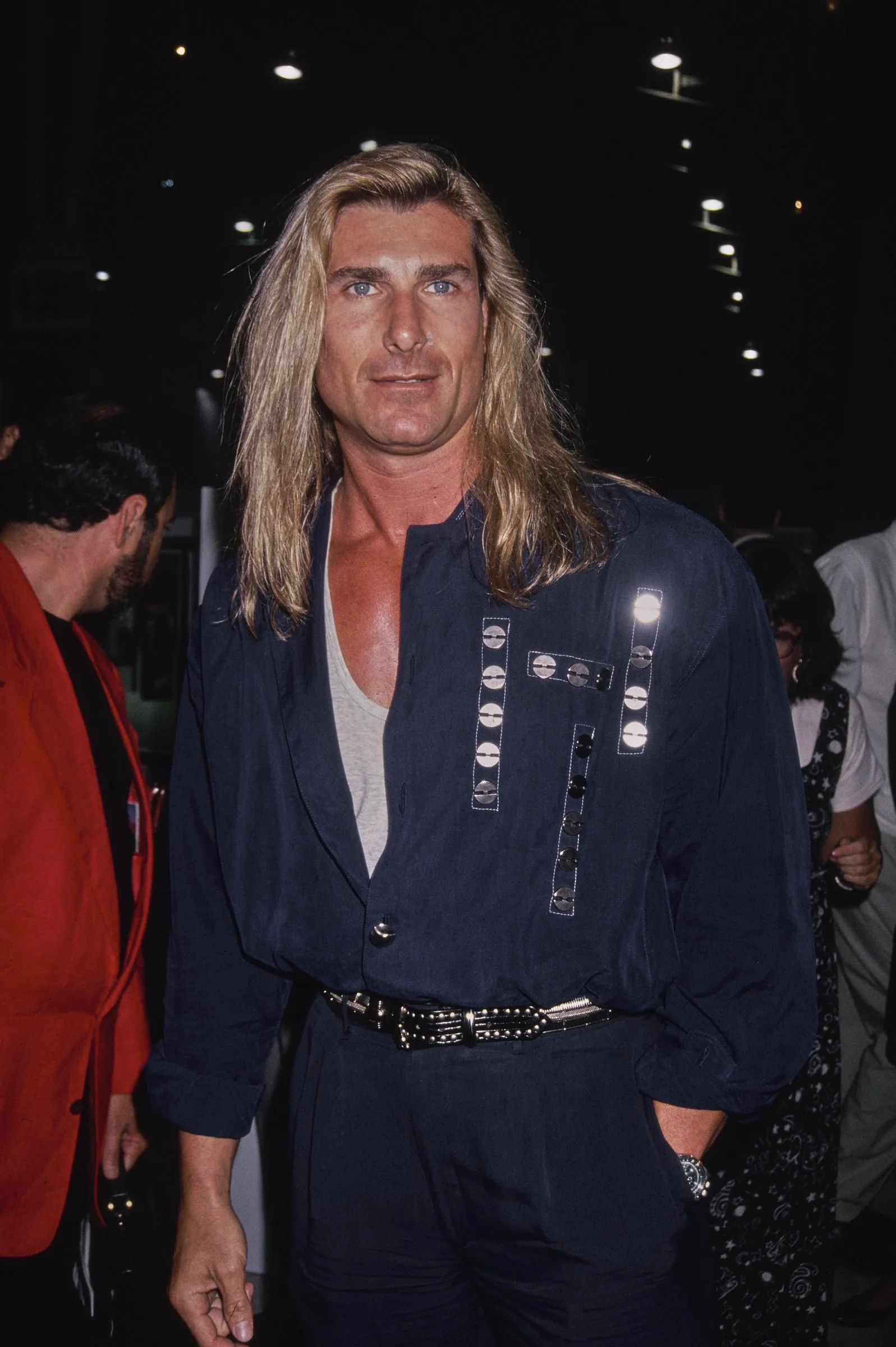 He walked out of that meeting with a lucrative contract in hand. In this photo, the iconic romance book cover star attended the "Pauly Does Dallas" premiere after party at the Comedy Store in Los Angeles, California, on August 26, 1992.