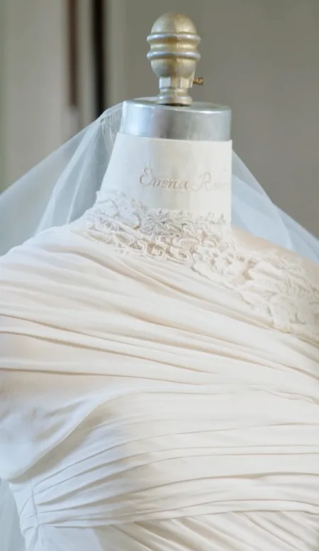 A closer look highlights the intricate draping, lace detailing, and veil on Emma Roberts' custom Monique Lhuillier wedding gown. The finished design reflected the vintage-inspired look Roberts envisioned for her wedding day.