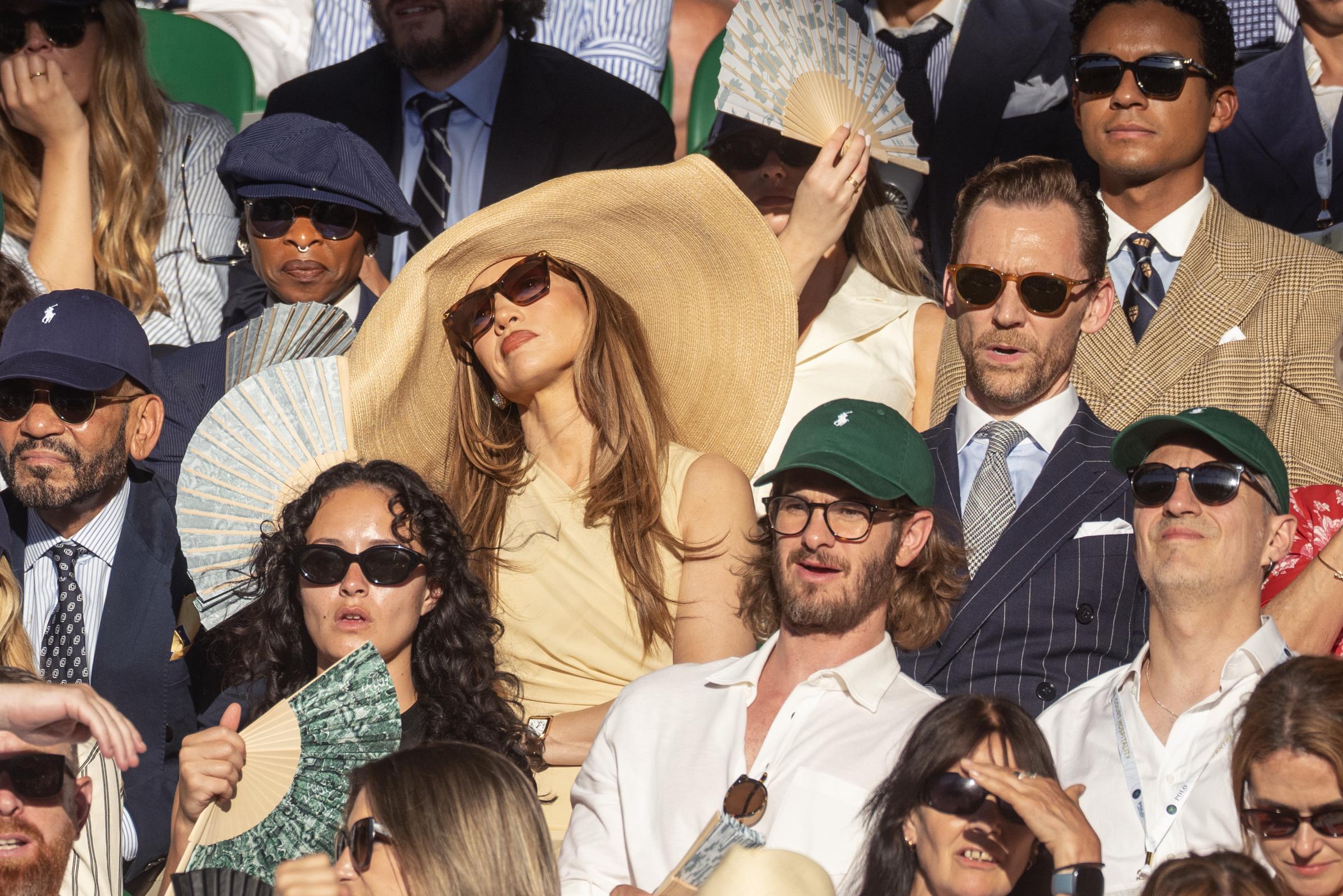 From a wider perspective, the brim's scale became difficult to ignore among the closely packed crowd. The image helped turn a luxury fashion moment into a much broader conversation about courtesy at major sporting events.