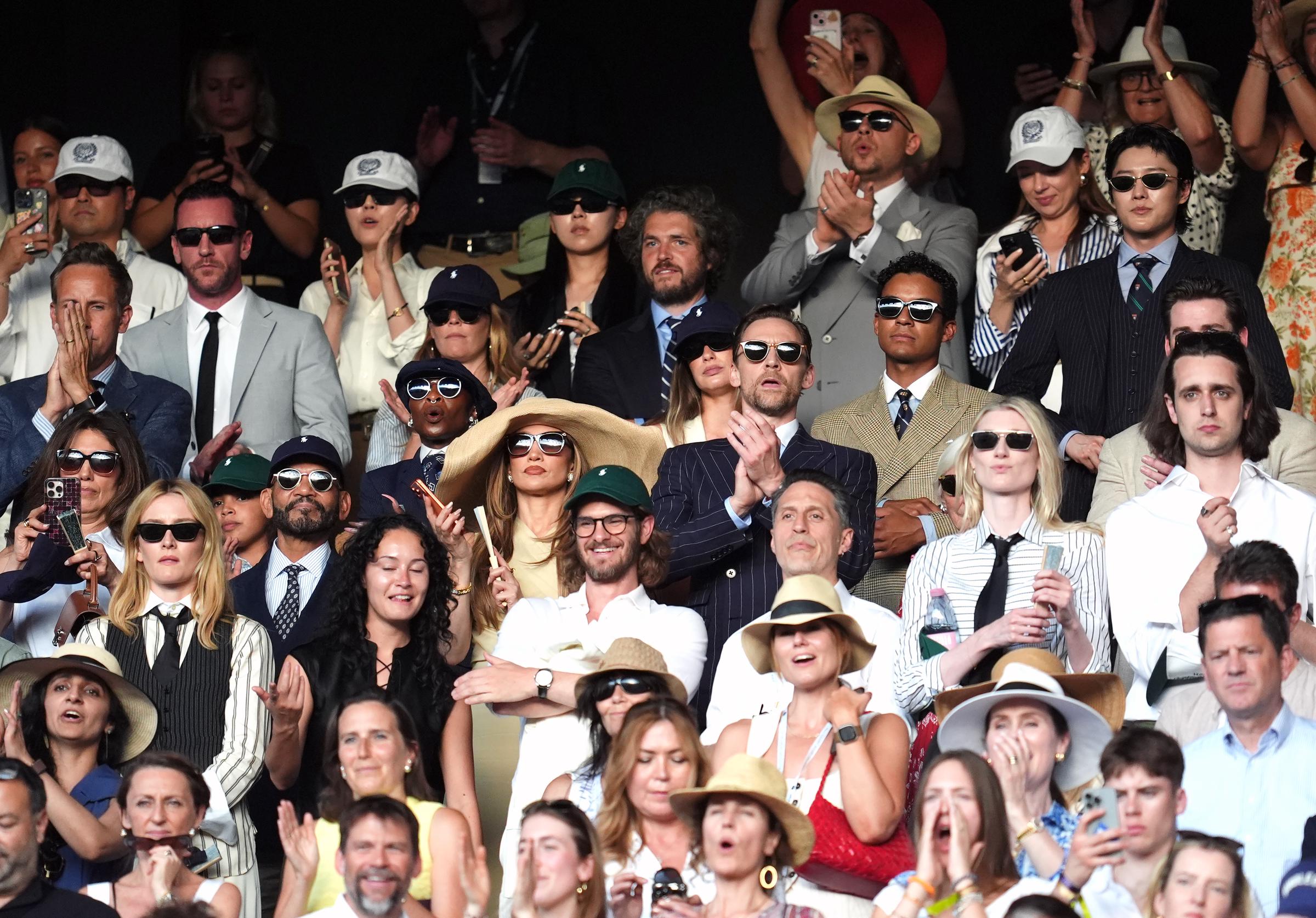 The celebrity-packed stands provided the wider context for why the accessory caused such a stir. In tightly arranged seating, even a fashionable statement can become a practical concern for spectators nearby.